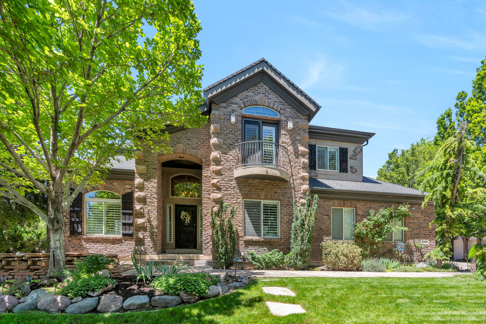 Stone and brick exterior with a prominent arched entry