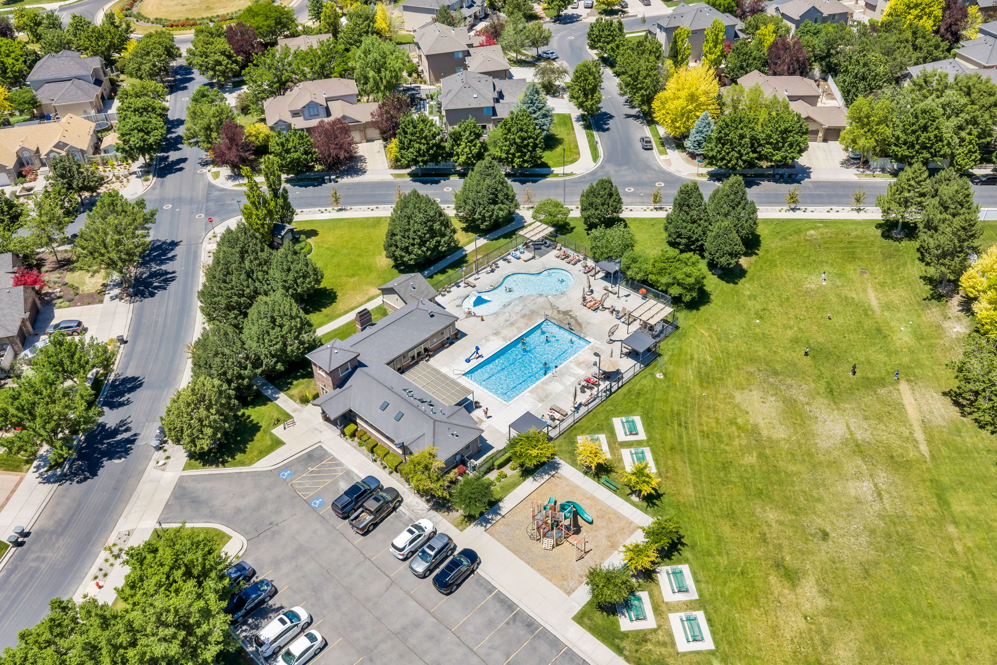 Community recreation area featuring a large swimming pool, separate children's pool, and multiple lounge chairs