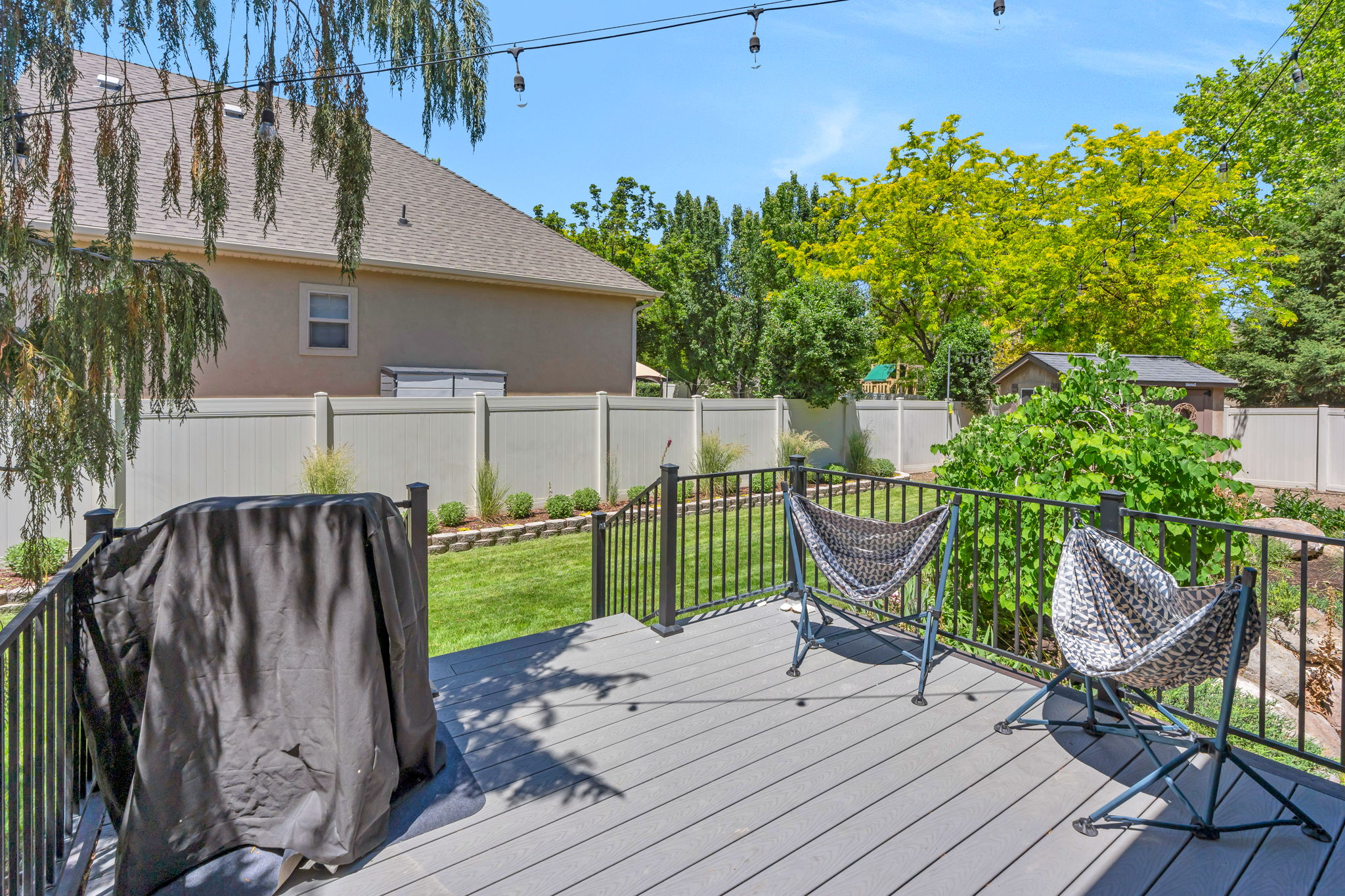 Expansive composite deck featuring black metal railings