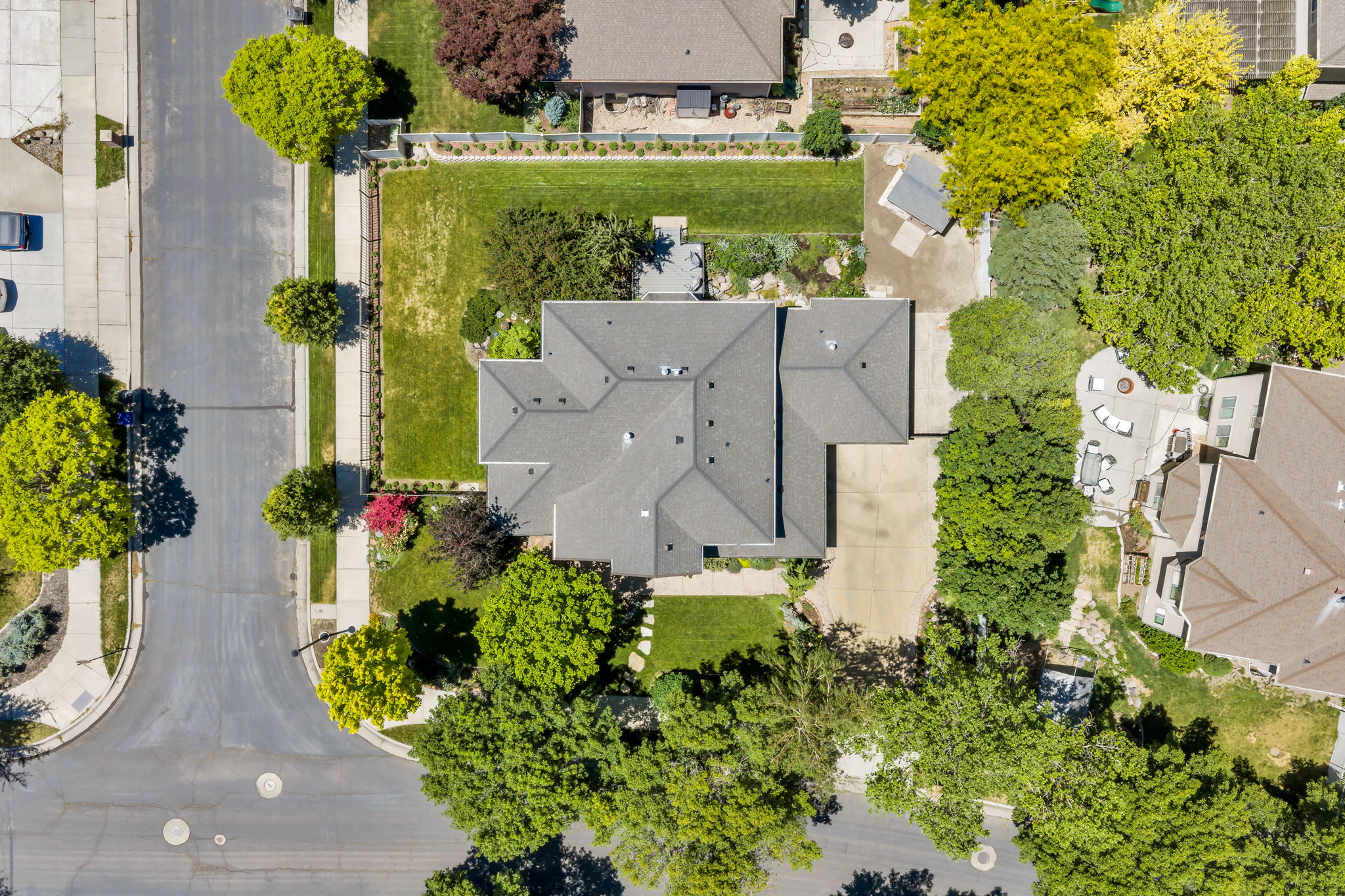 Property featuring a multi-gabled roofline and an expansive, manicured lawn