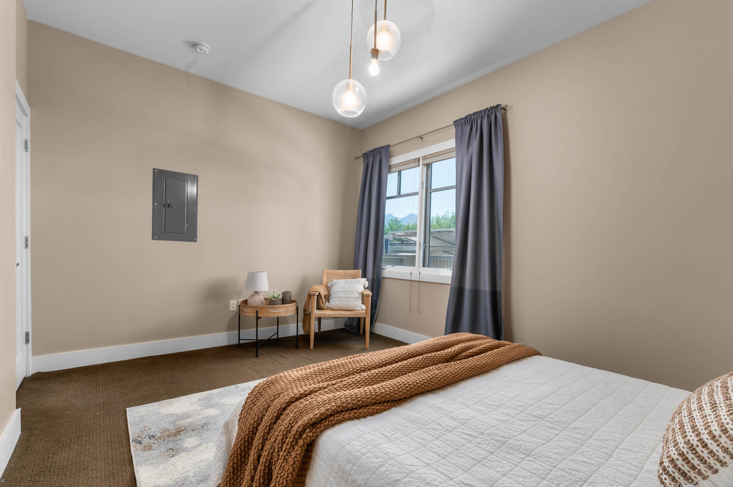 Carpeted room with neutral wall paint, white baseboards, and a double-pane window