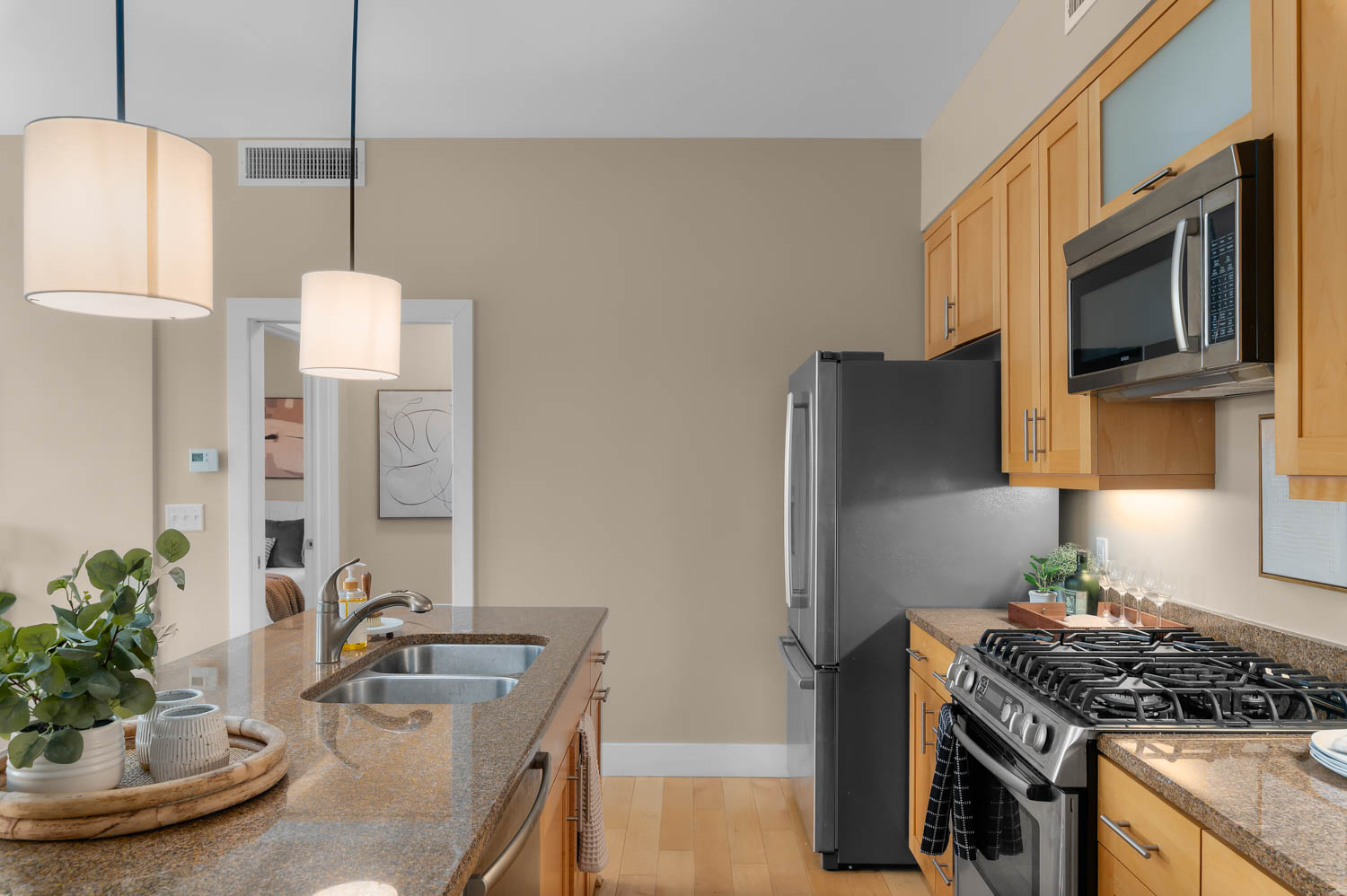 Kitchen featuring a stainless steel gas range, microwave, and refrigerator