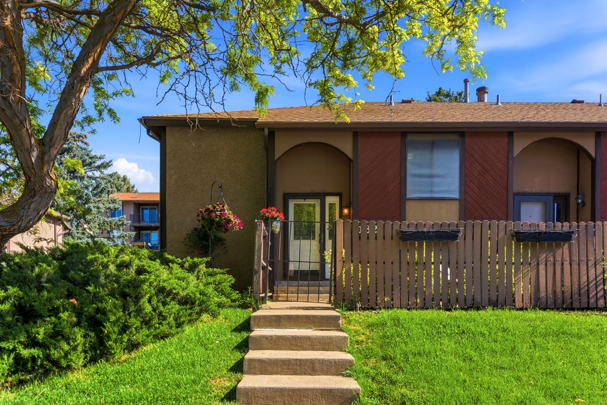 Property exterior featuring a brown stucco finish with arched architectural details