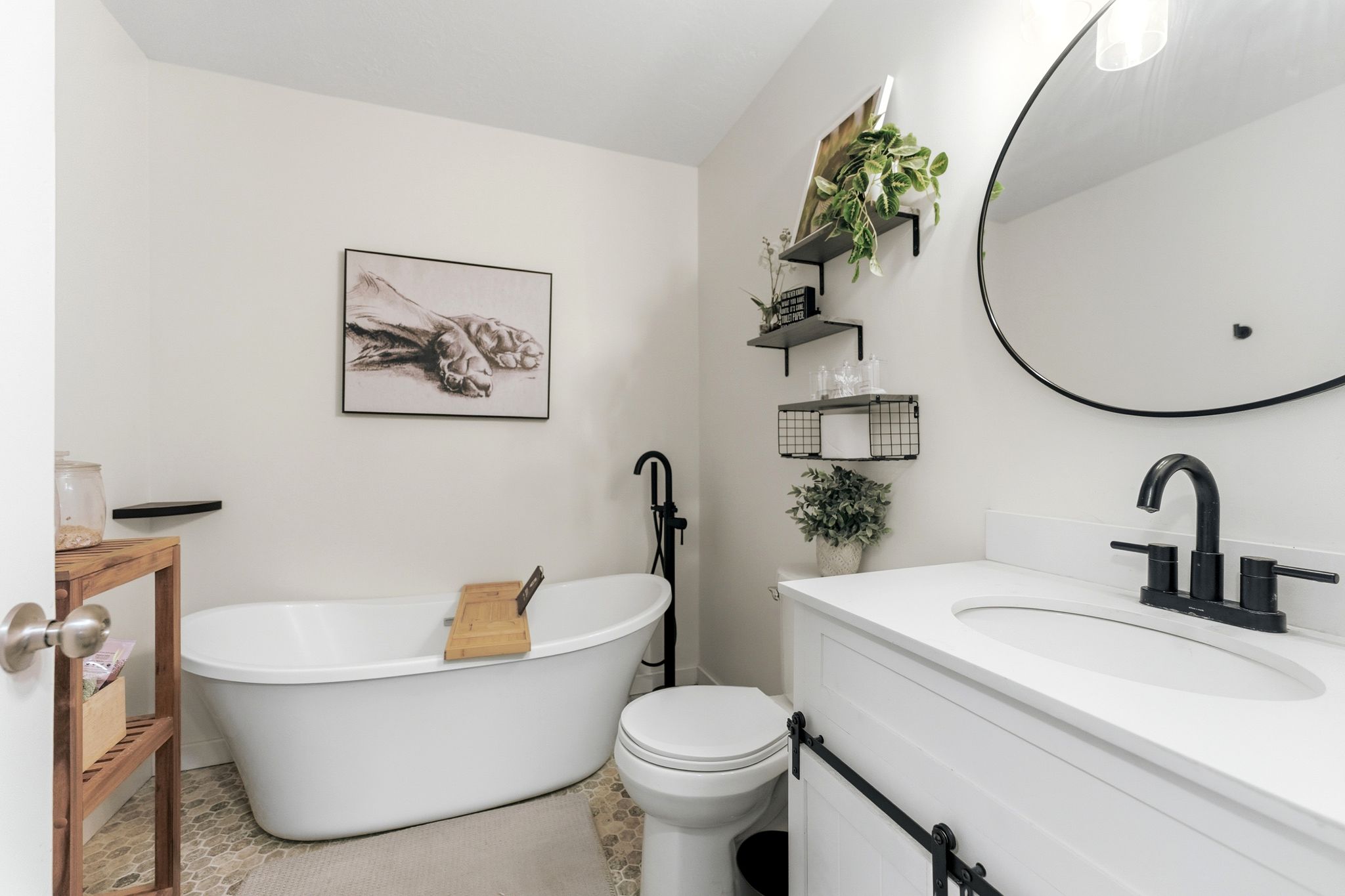 Freestanding bathtub with floor-mounted matte black faucet