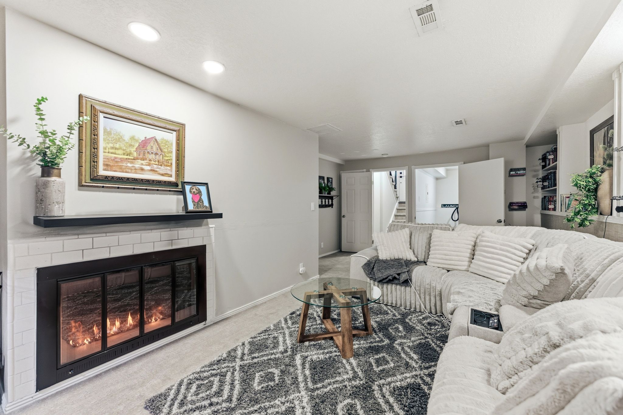 Living area featuring a gas fireplace with white subway tile surround and a black floating mantel