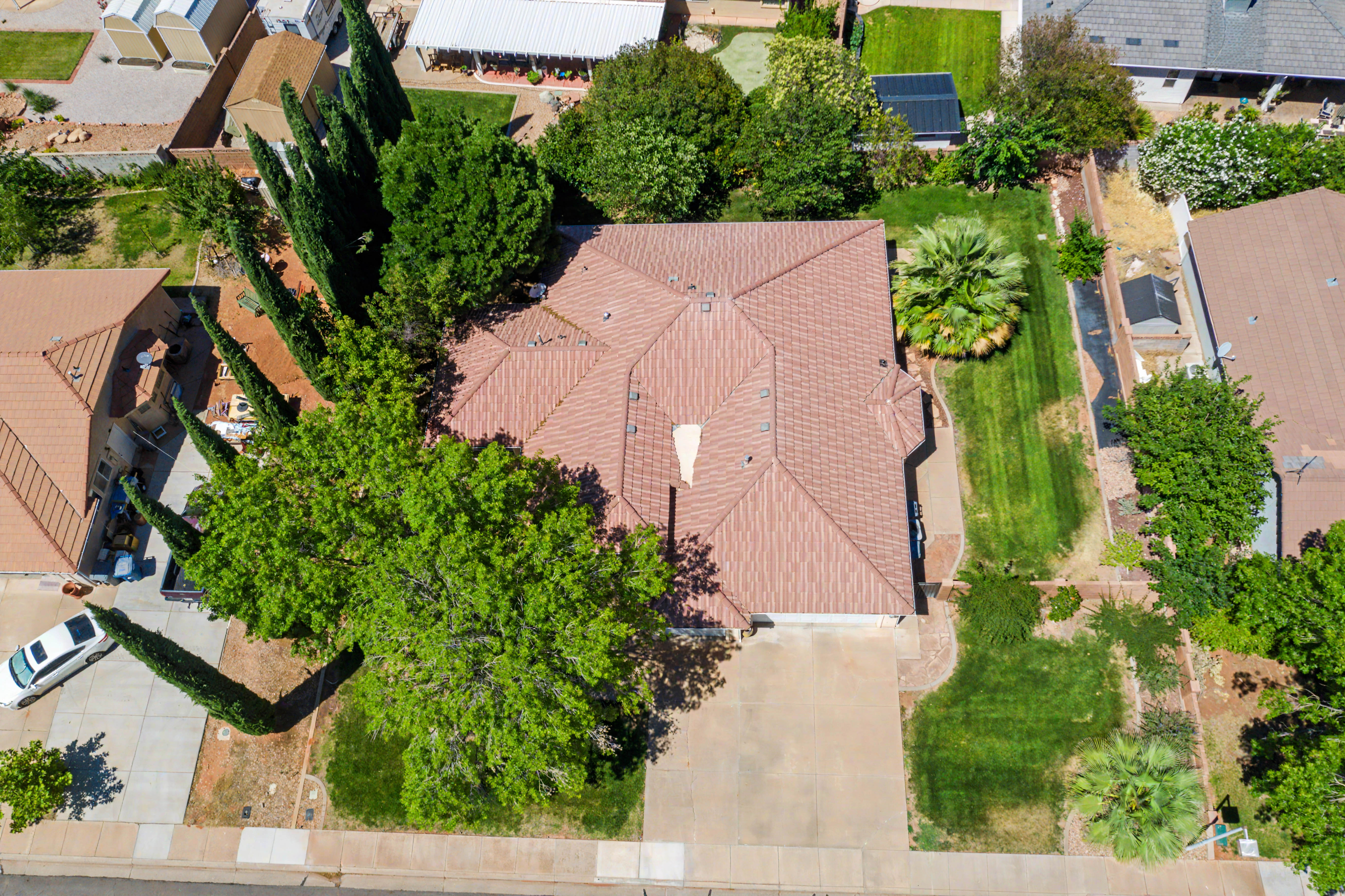 Aerial perspective showcasing a single-story residence with a brown tile roof and an attached garage