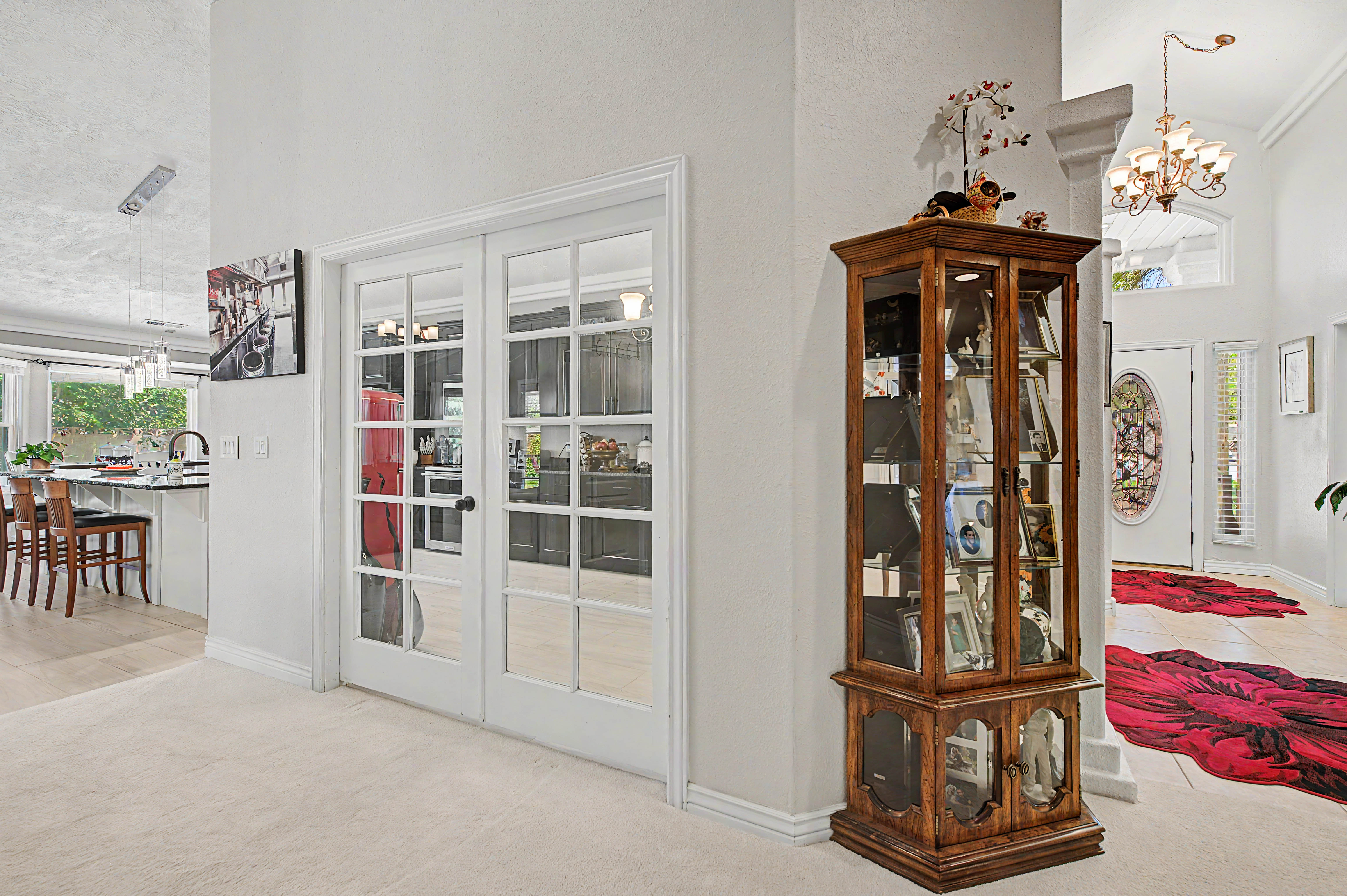 French doors with transom windows, recessed lighting, and light-colored carpeting