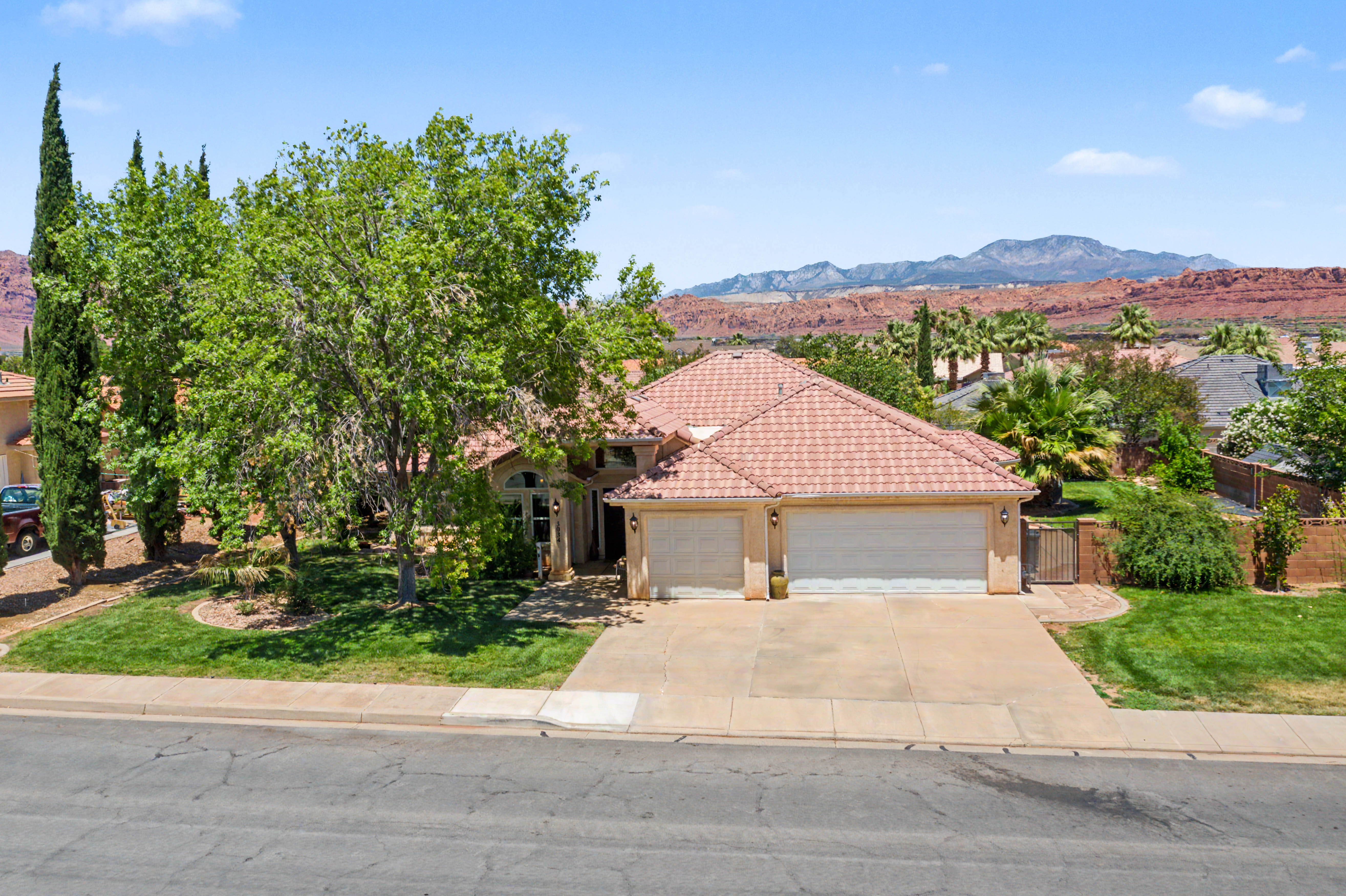 Single-story residence featuring a tile roof and an attached two-car garage