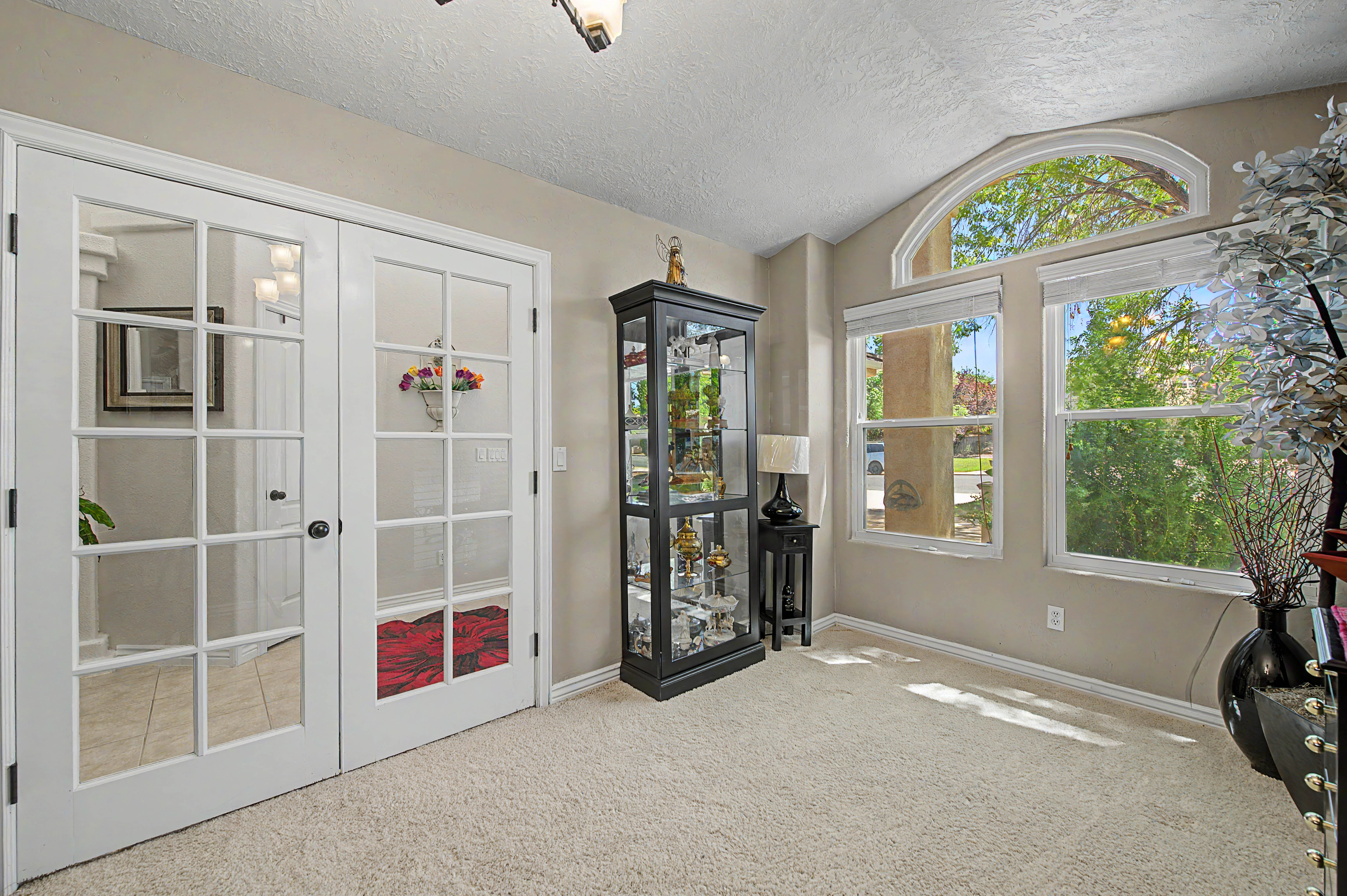 Room featuring a vaulted ceiling and neutral wall tones