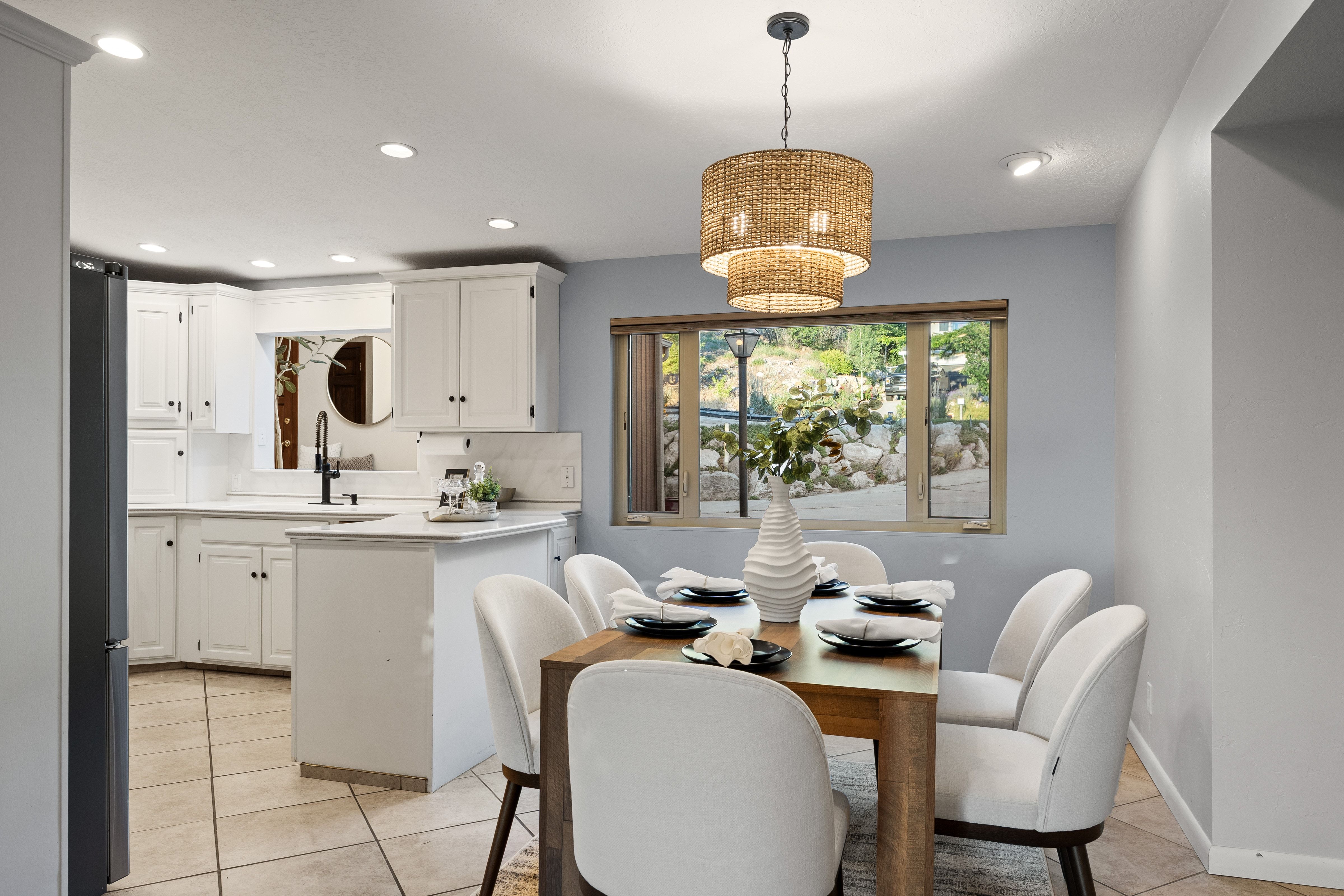 Dining area featuring a woven pendant light fixture and recessed ceiling lights