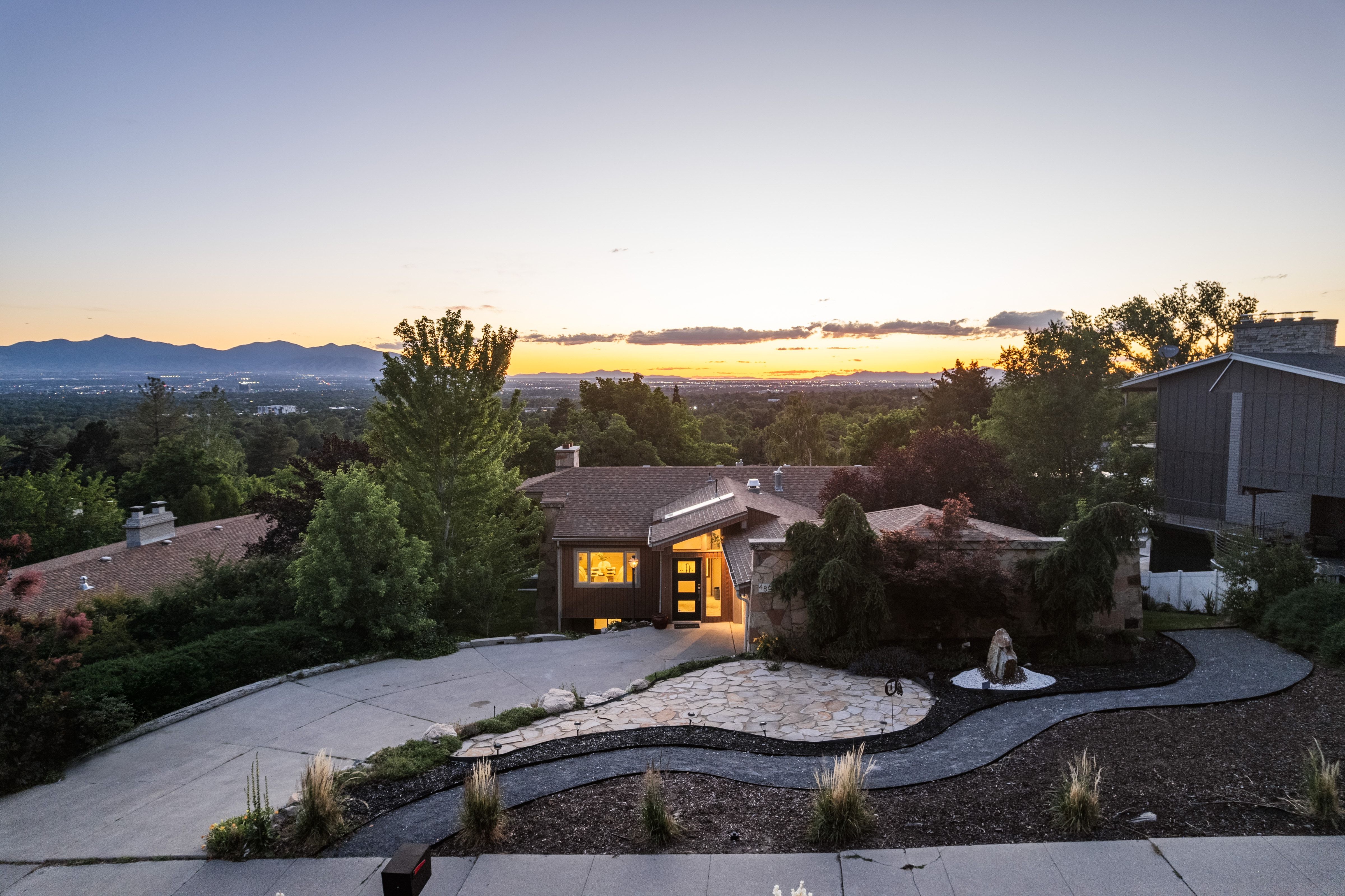 Contemporary-style residence with a distinct sloped roofline and a multi-pane front door