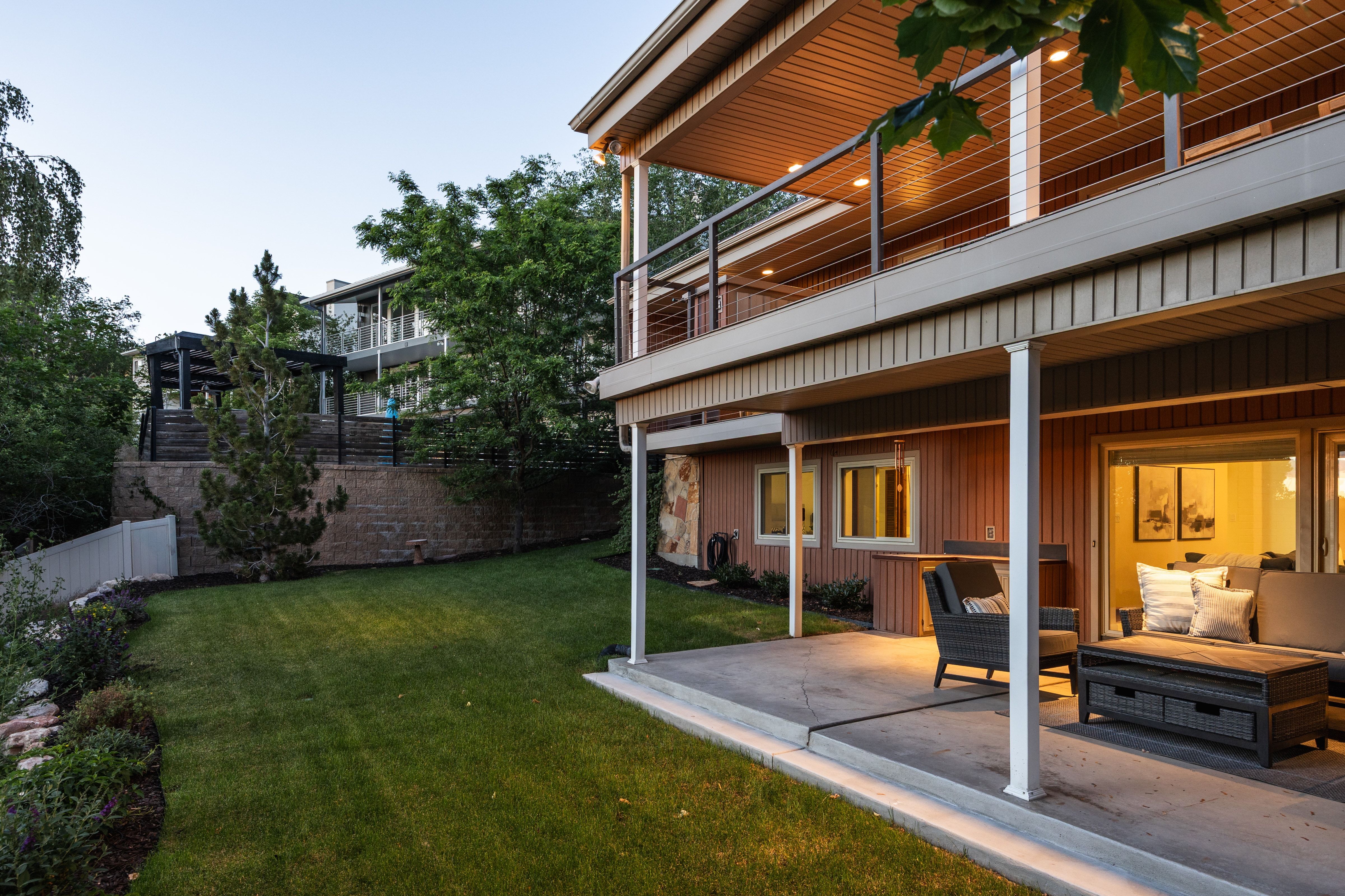 Ground-level patio with recessed lighting and direct access to a private lawn