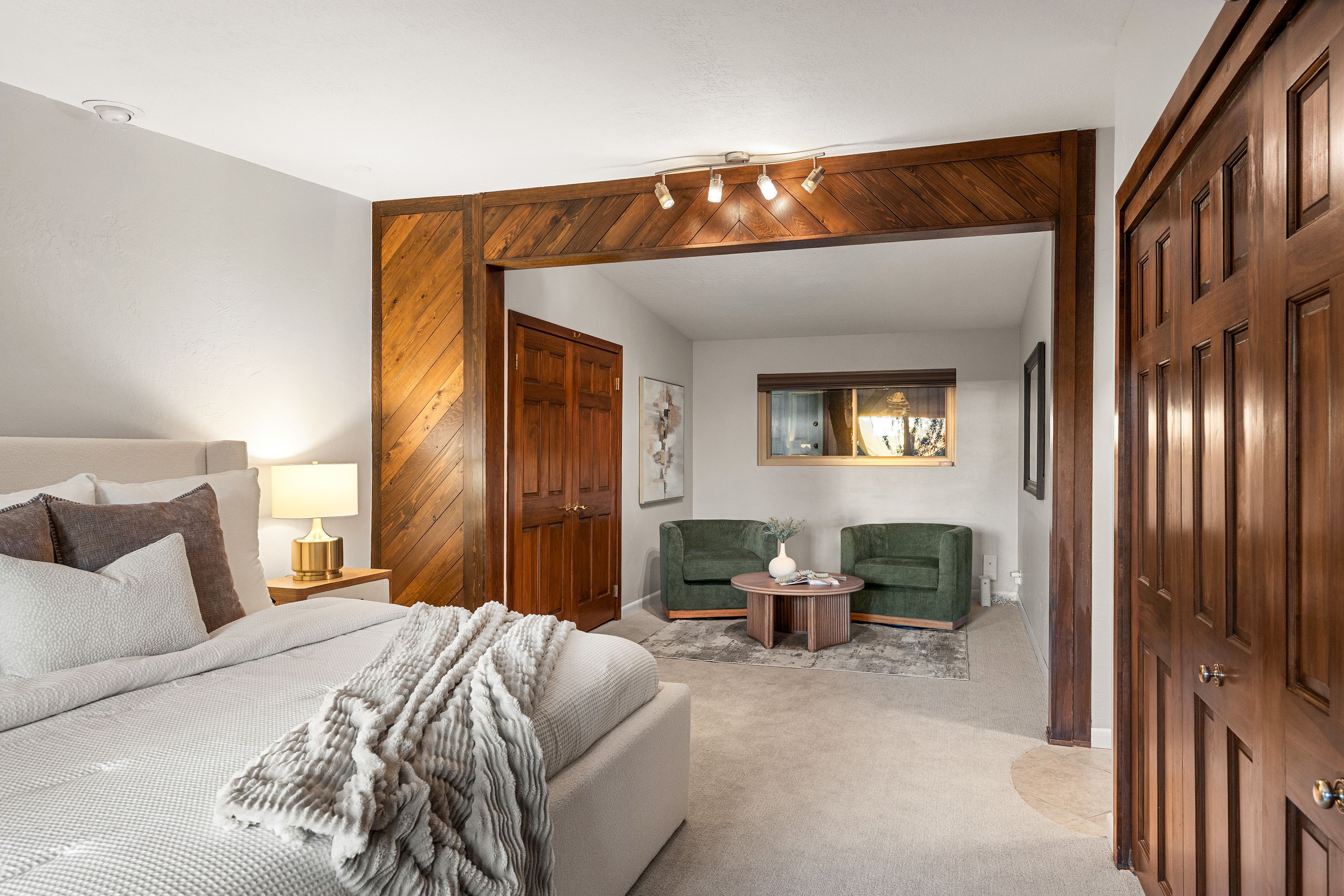 Bedroom space featuring a recessed sleeping area and an adjoining sitting area