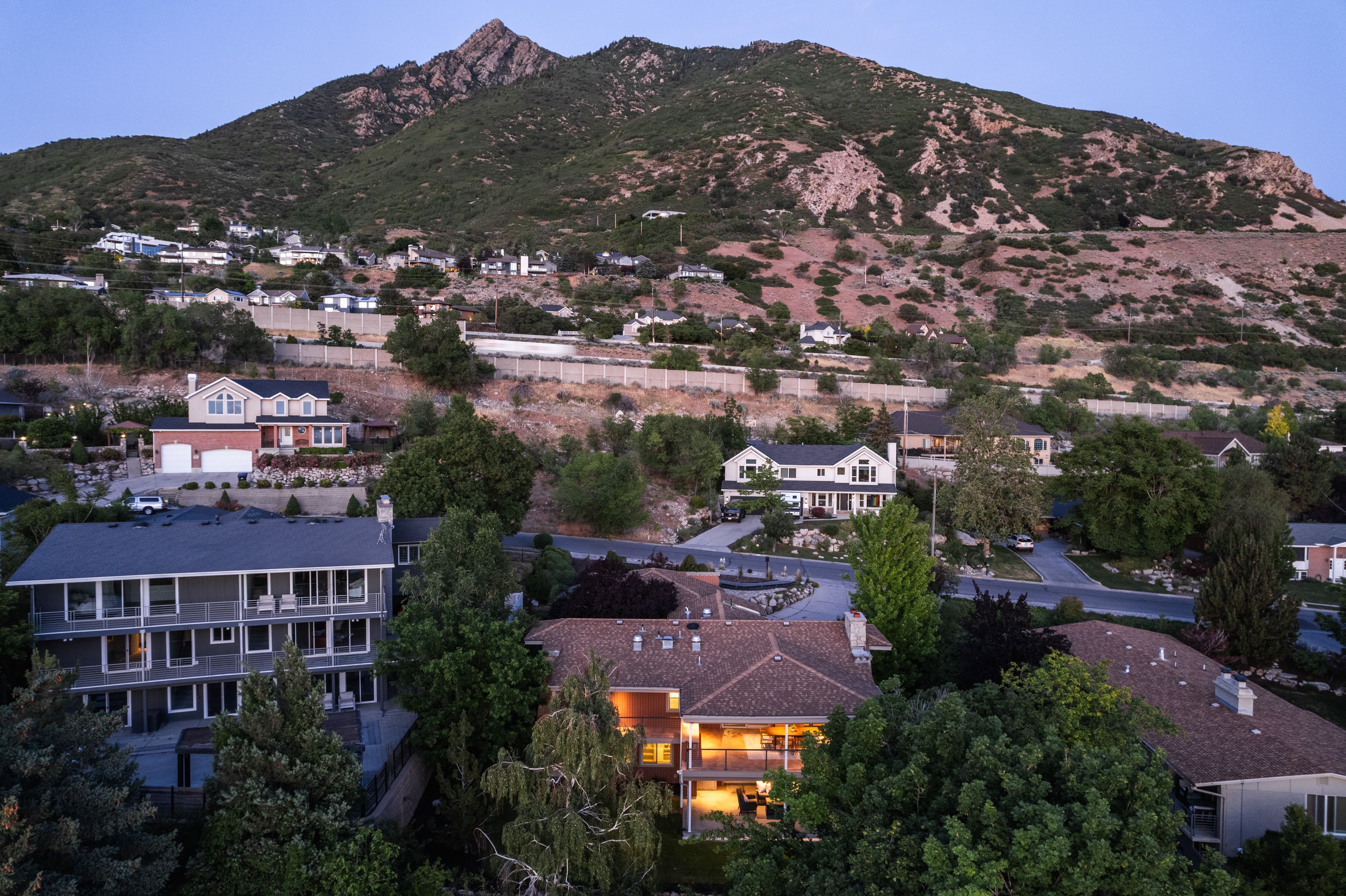 Multi-level residential property with a prominent mountain backdrop