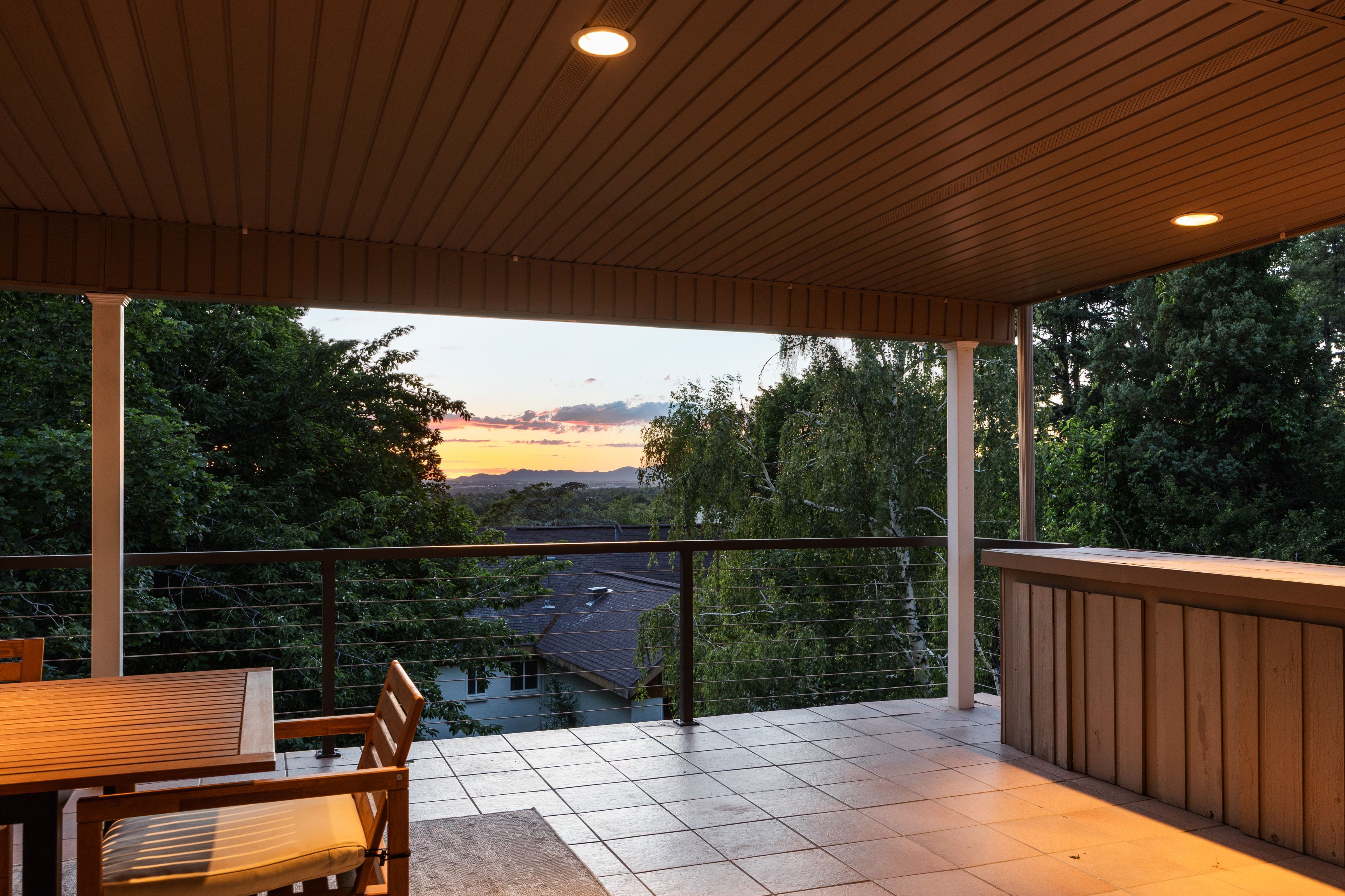Covered outdoor patio featuring recessed lighting, a built-in bar, and a cable railing system
