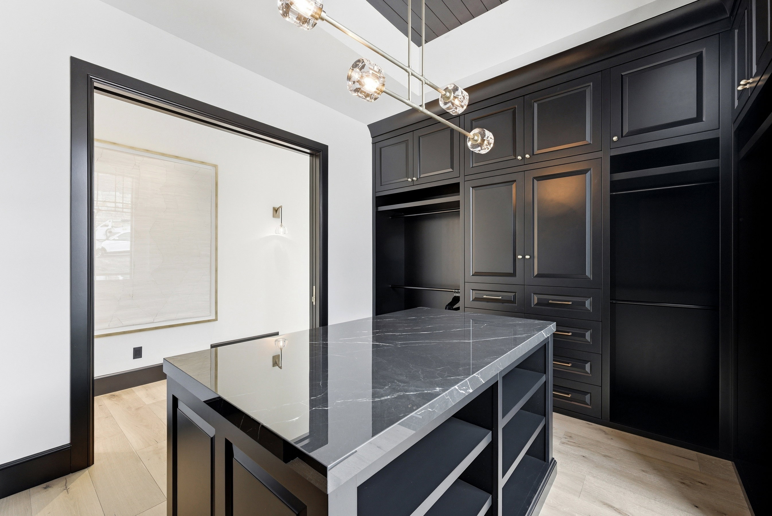 Custom built-in cabinetry with panel doors and gold-tone hardware