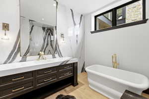 Bathroom featuring a floating dark wood vanity with ample storage, a white countertop, and a large wall-mounted mirror