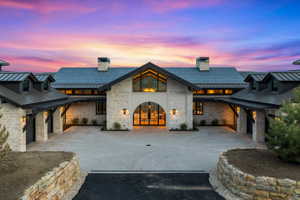 Stone masonry exterior with a gabled roofline and black metal roofing
