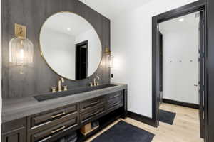 Dual vanity with integrated concrete sink and gold-finish fixtures