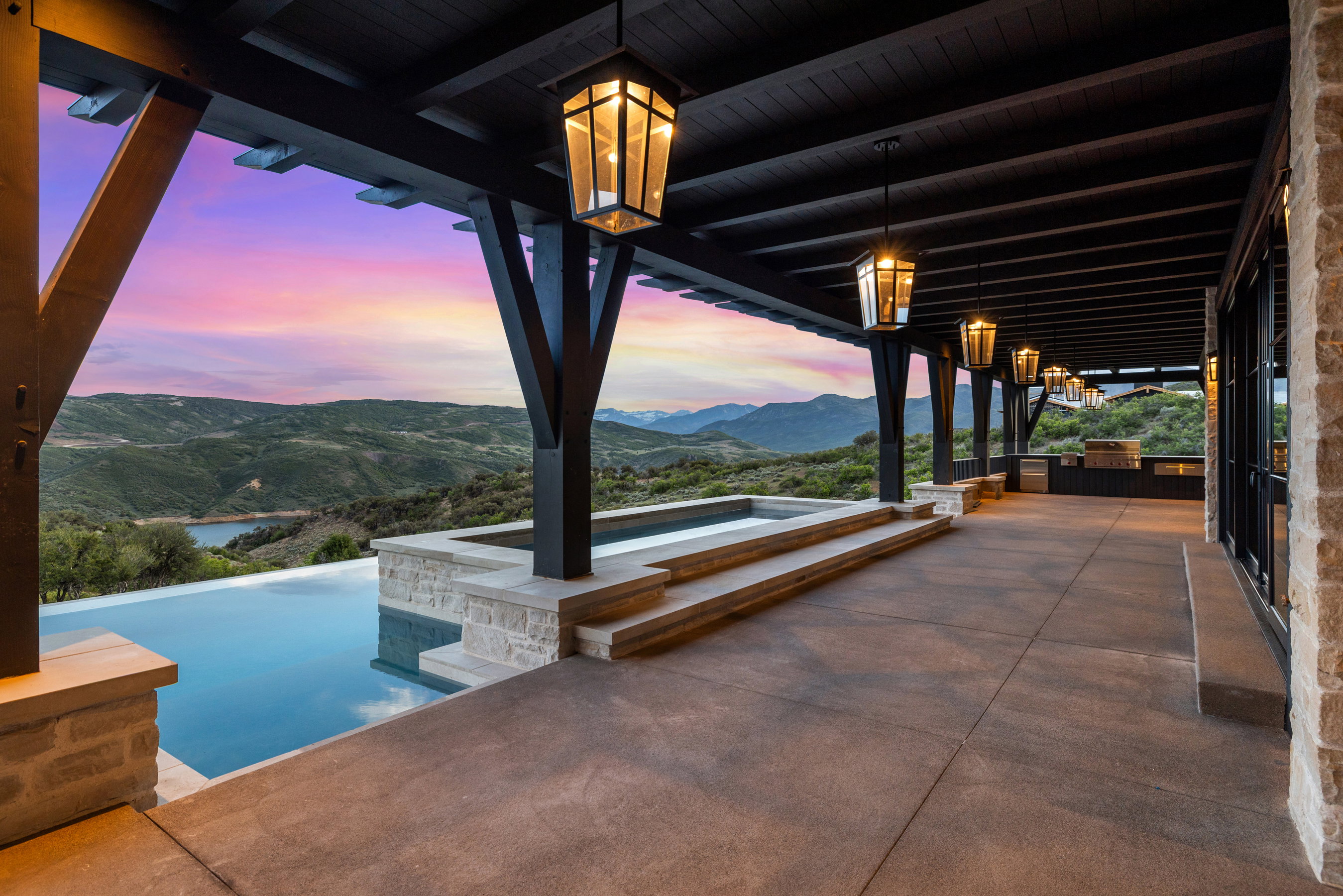 Expansive patio with an infinity-edge pool and integrated spa