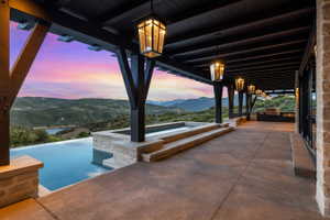 Expansive patio with an infinity-edge pool and integrated spa