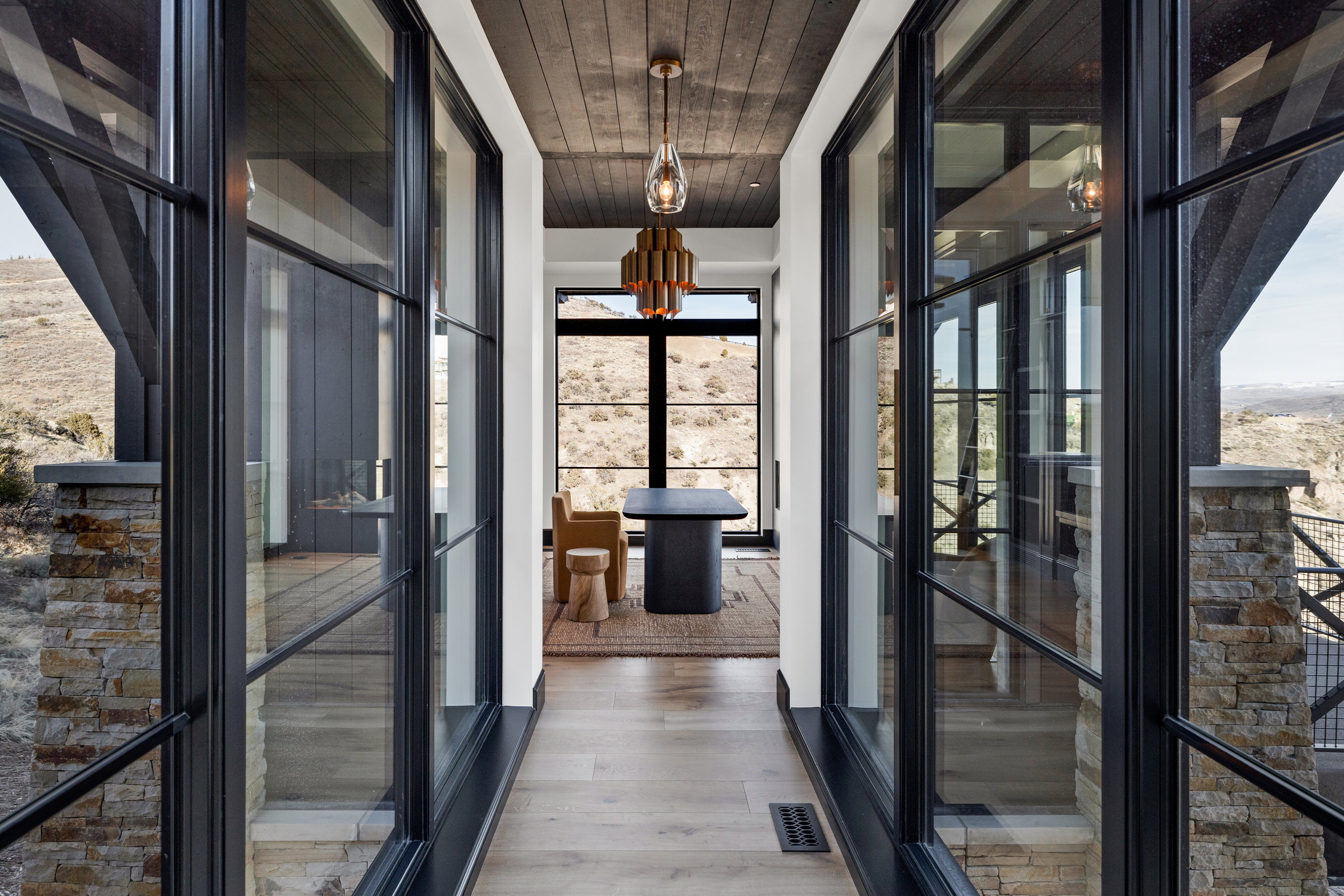 Hallway featuring light wood-finish flooring, a dark wood-paneled ceiling, and recessed lighting