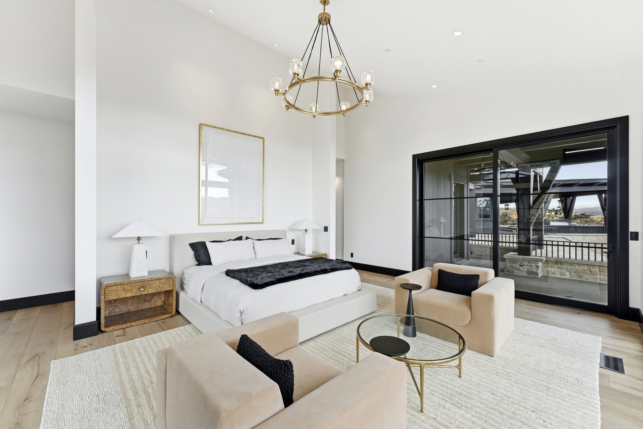 Spacious bedroom featuring light wood-finish flooring and a neutral color palette