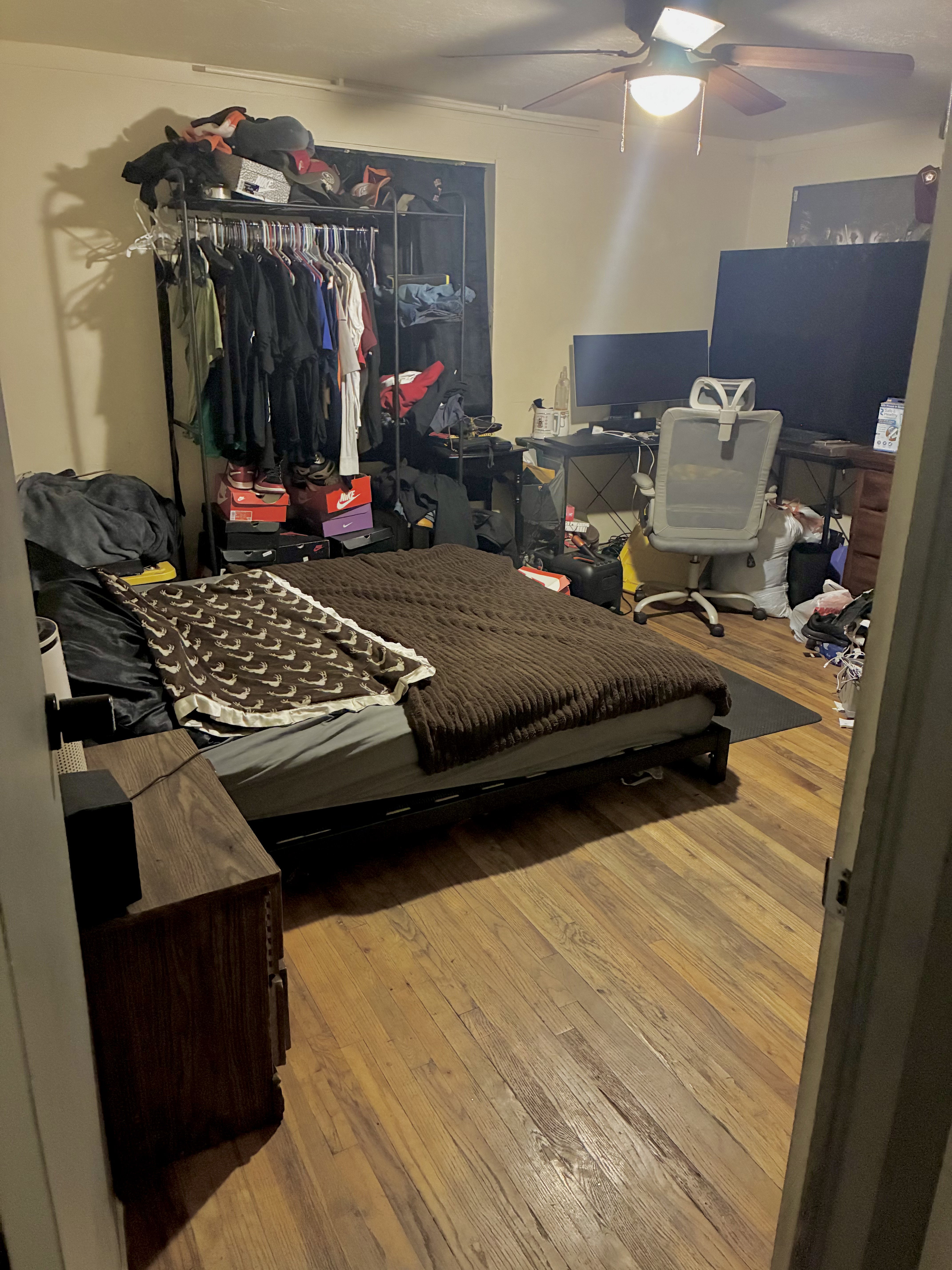 Room featuring hardwood flooring and a ceiling fan