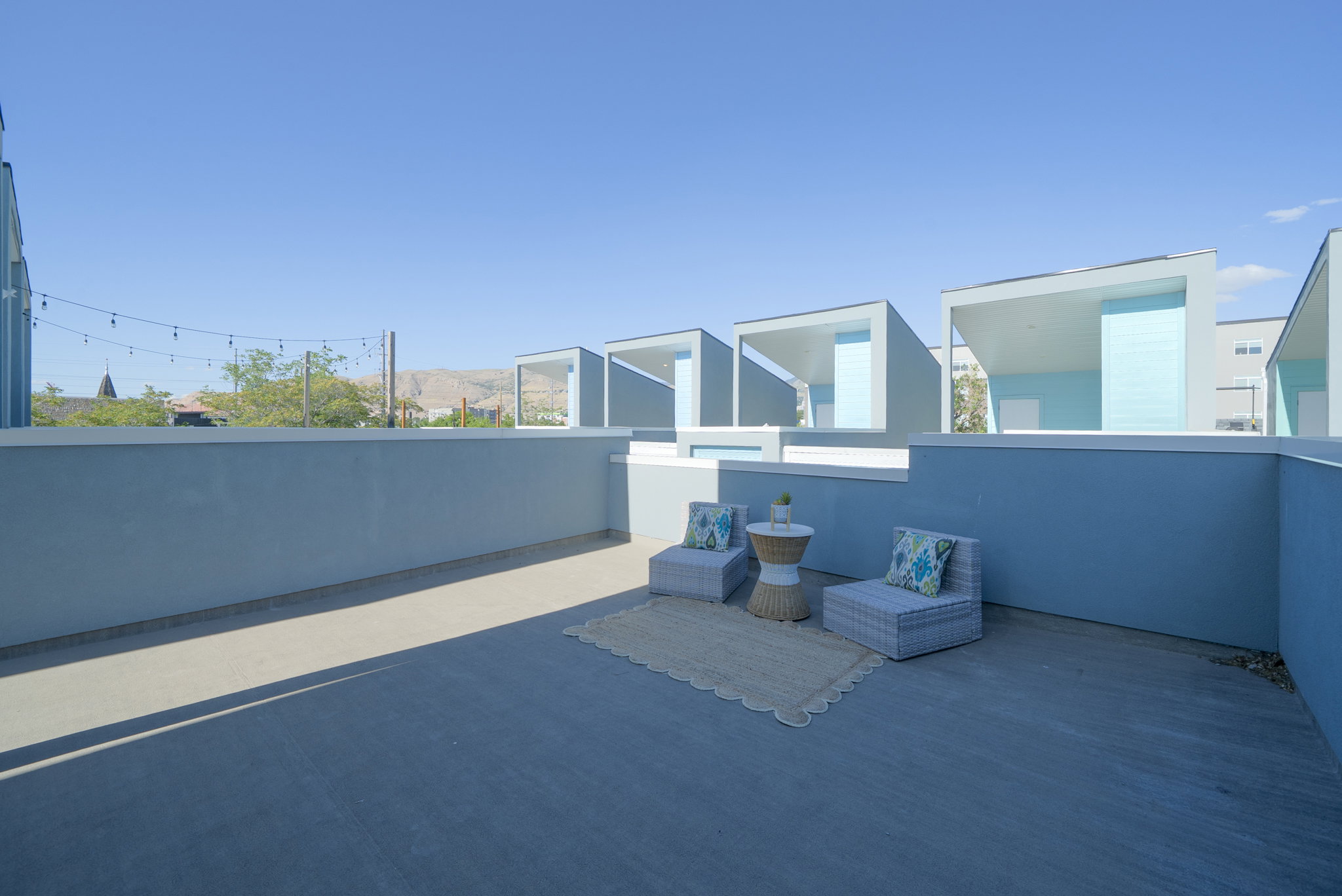 Expansive outdoor patio space with painted concrete flooring and perimeter walls