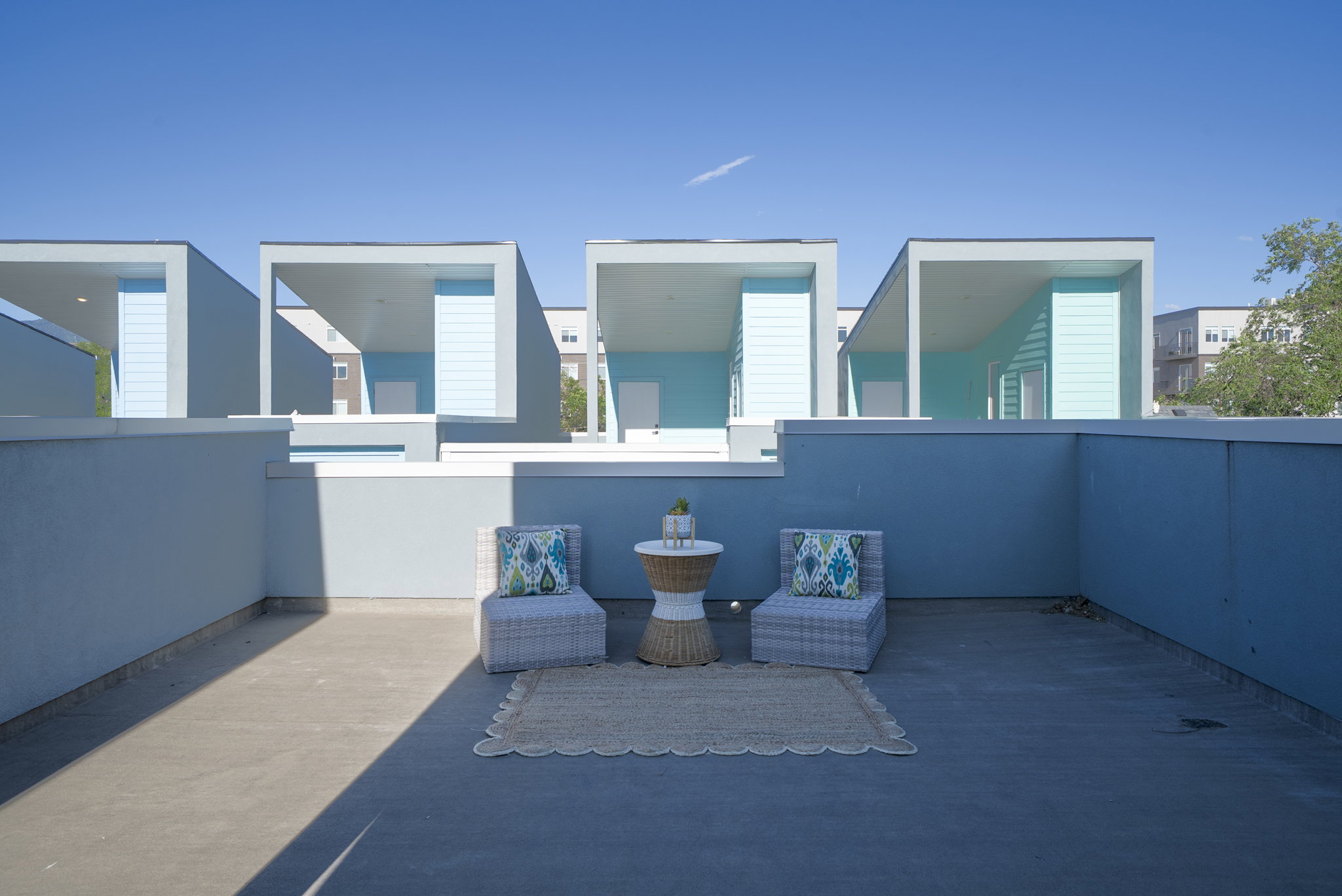 Rooftop patio with light-toned concrete flooring and high perimeter walls