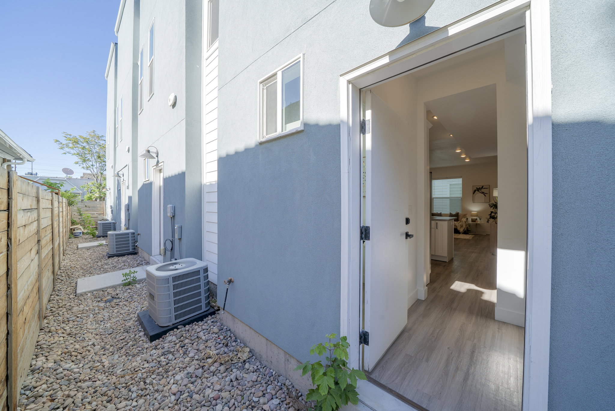 Entryway featuring a white door, light wood-finish flooring, and recessed lighting