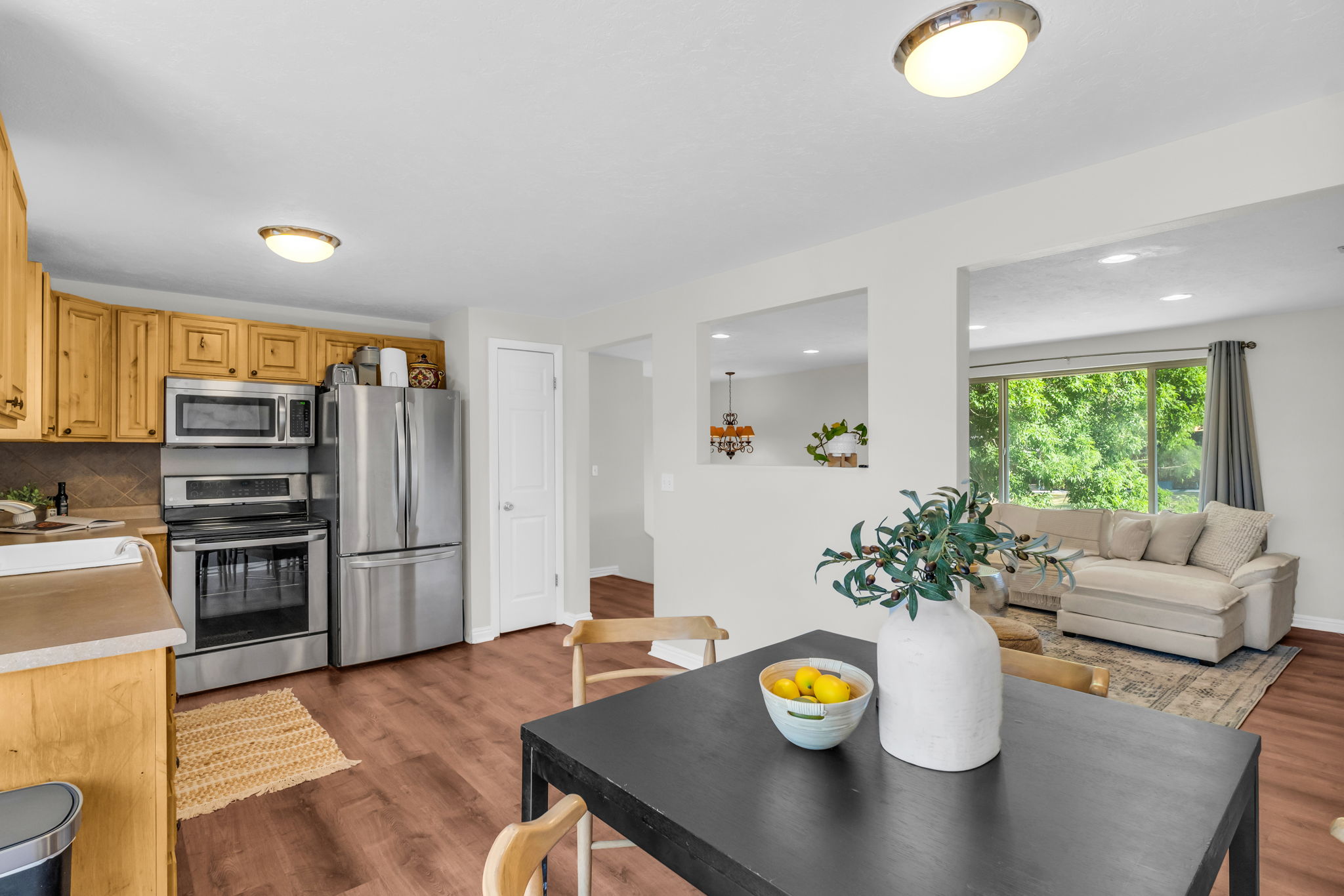 Kitchen and dining area featuring wood-finish flooring