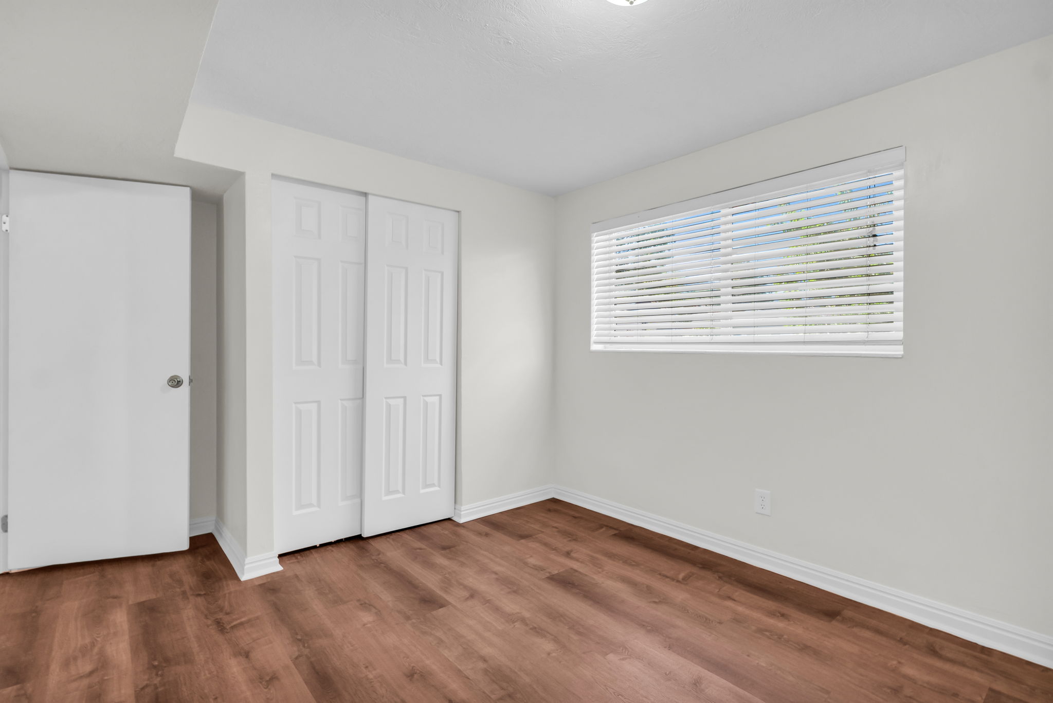 Neutral white walls with wood-finish flooring