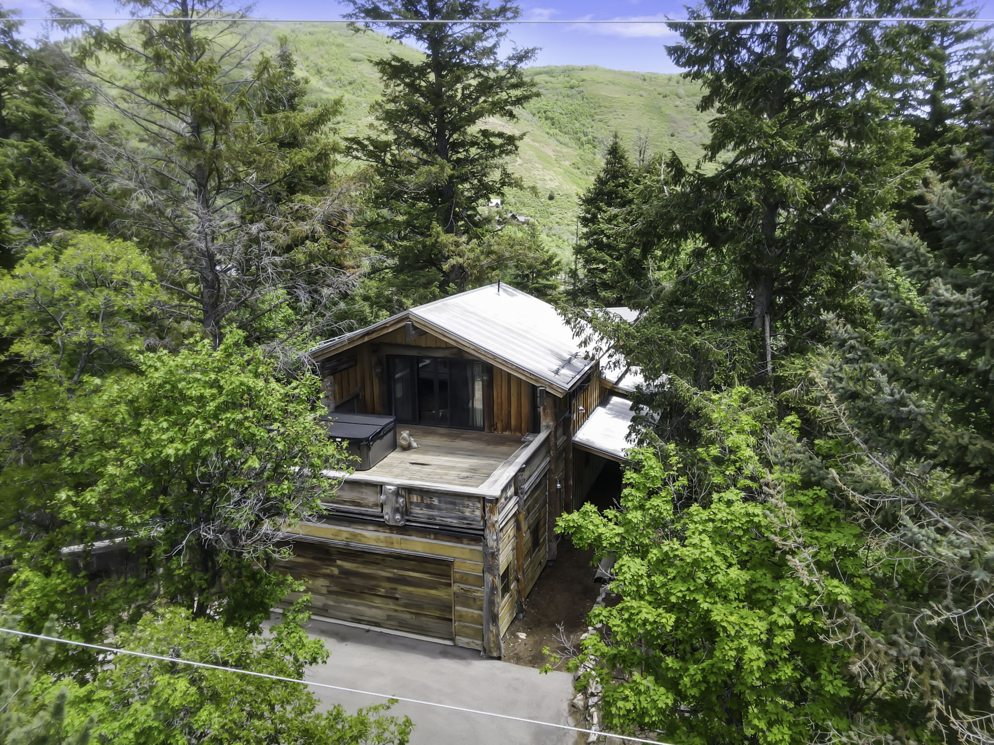 Rustic-style residence featuring natural wood siding and a metal roof