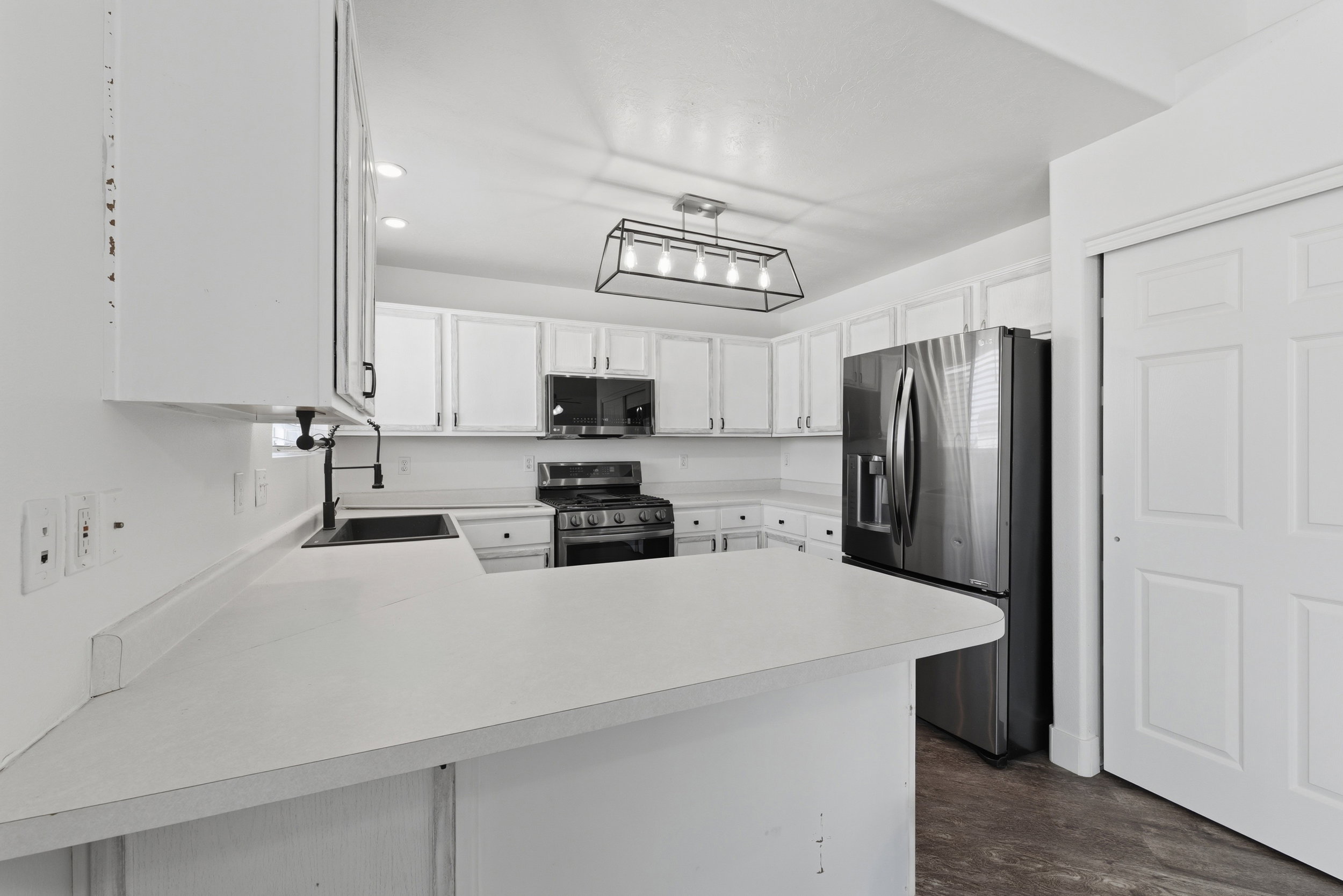 Modern kitchen with white cabinetry and light countertops