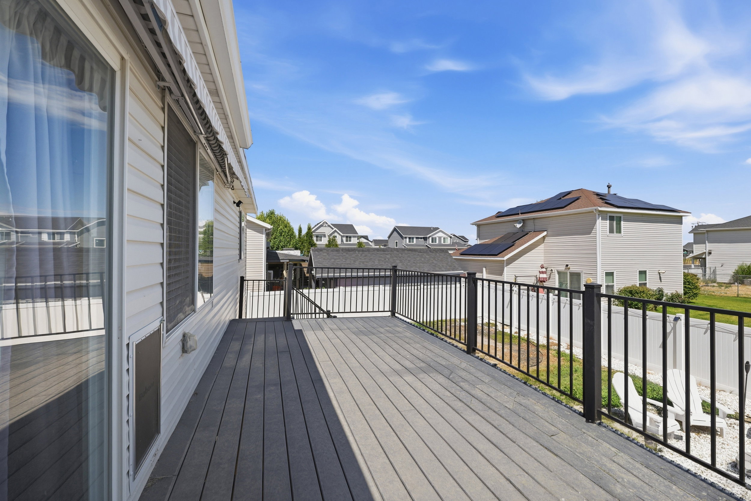 Spacious composite deck with black metal railings