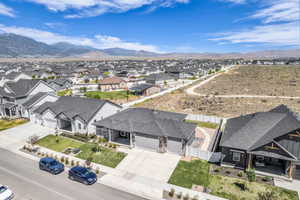 New construction neighborhood featuring multiple architectural styles and mountain backdrops
