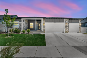 Modern facade featuring stone accents and dark siding