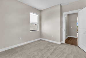 Neutral-toned carpeting paired with light-colored walls and white trim