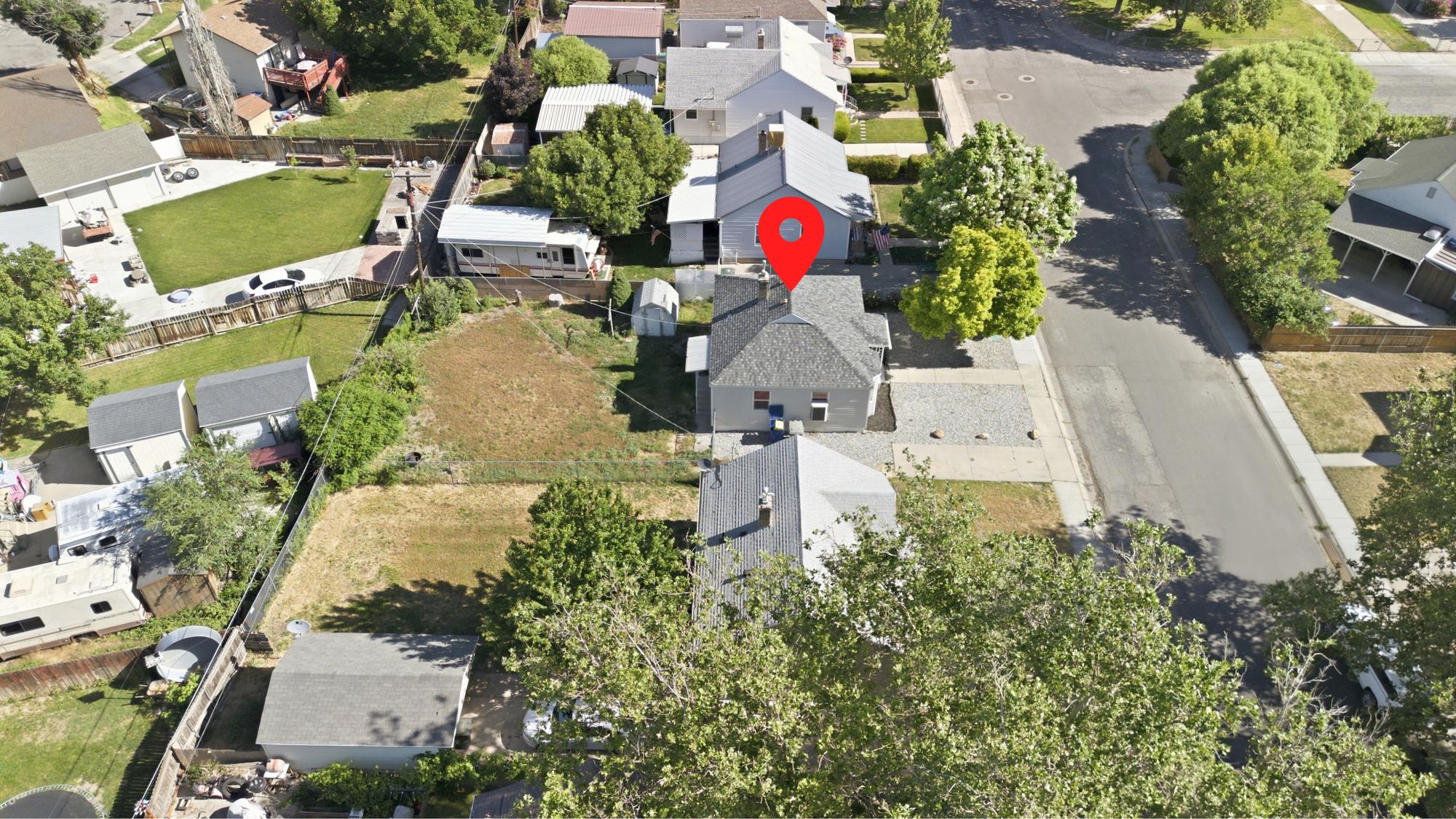Elevated aerial view showcasing the home’s location within the neighborhood and nearby streets.