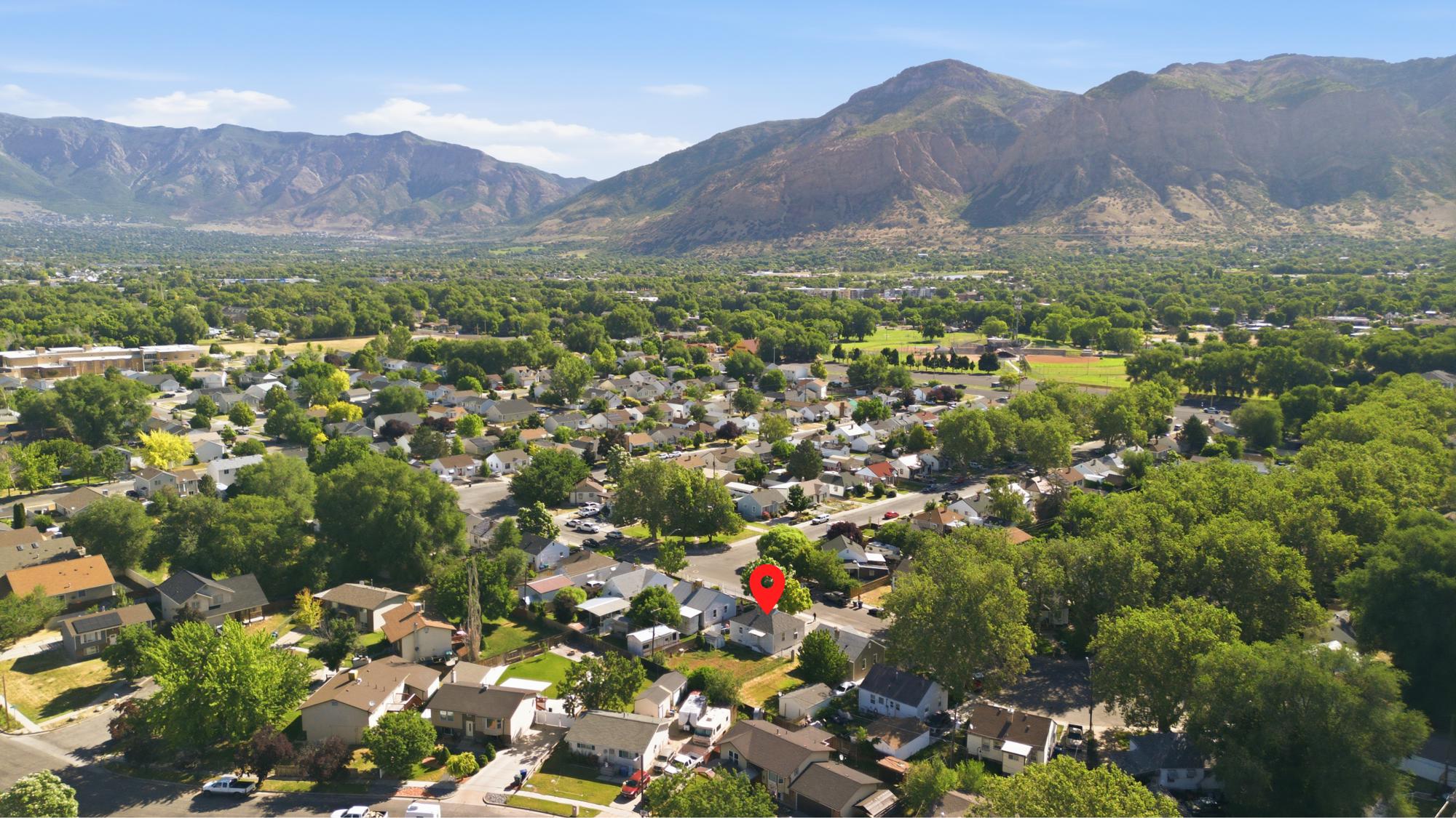Aerial neighborhood view with property location marked and nearby residential surroundings.