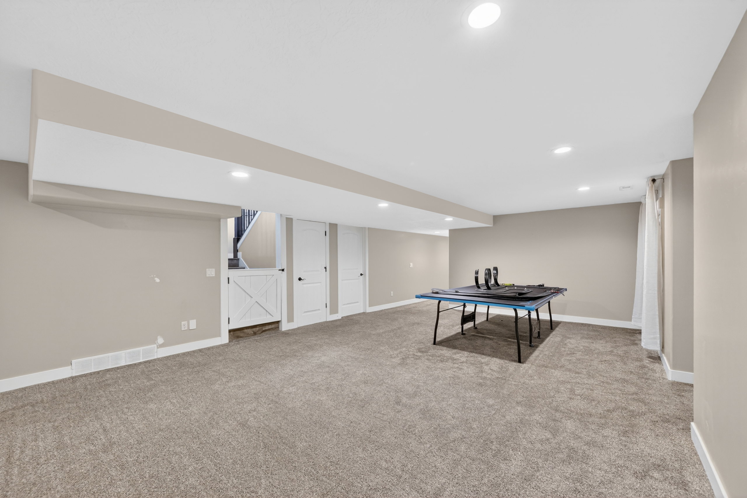 Expansive carpeted room featuring recessed lighting and neutral wall tones