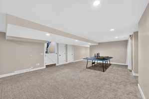 Expansive carpeted room featuring recessed lighting and neutral wall tones