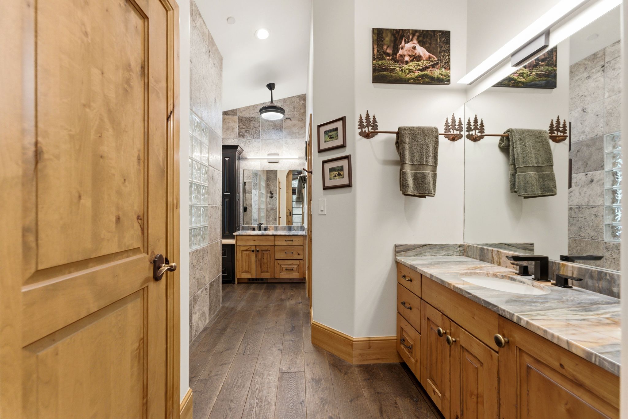 Double vanity featuring stone countertops and integrated sinks with matte black fixtures