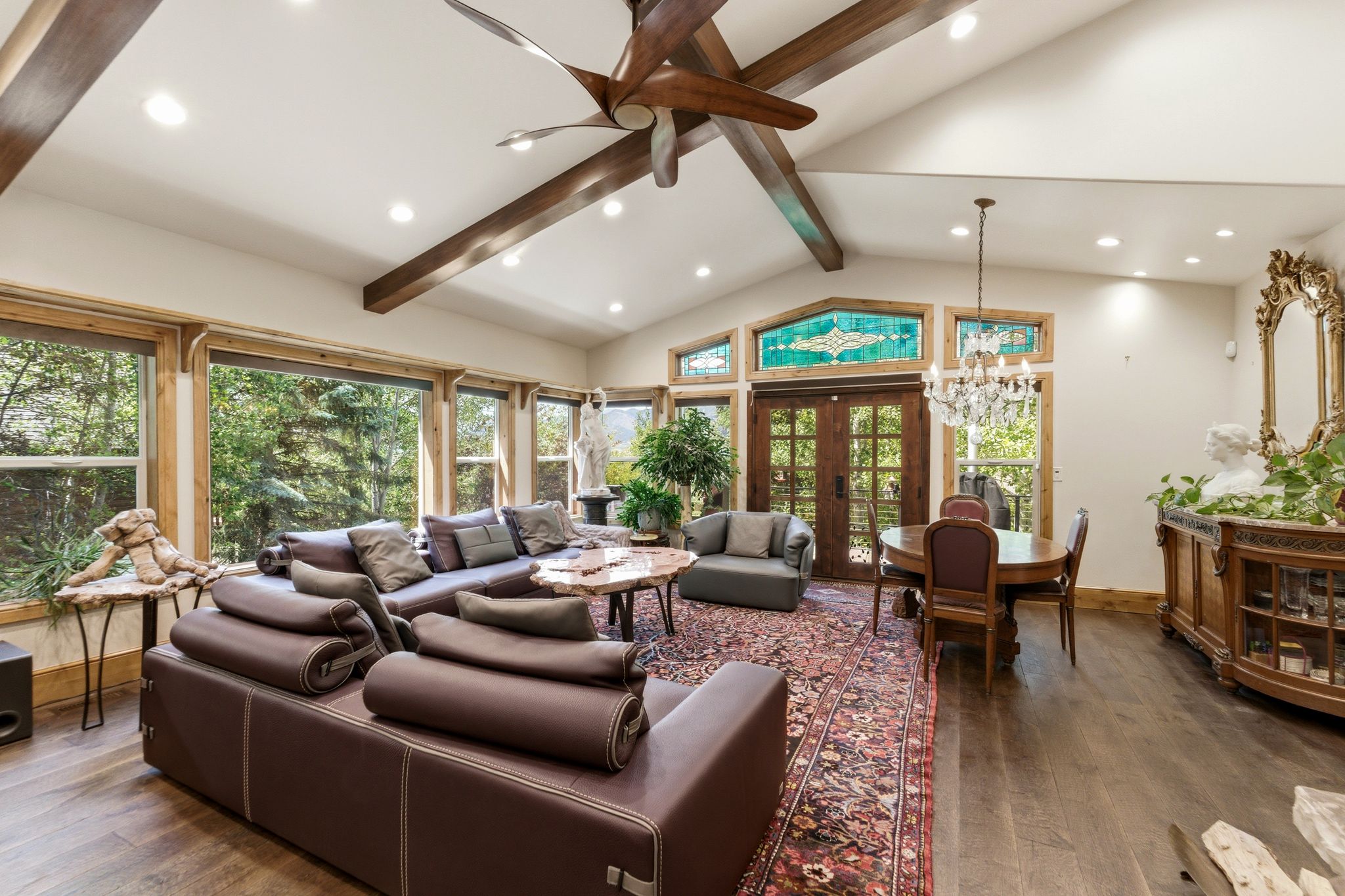 Vaulted ceiling with exposed wood beams and a ceiling fan