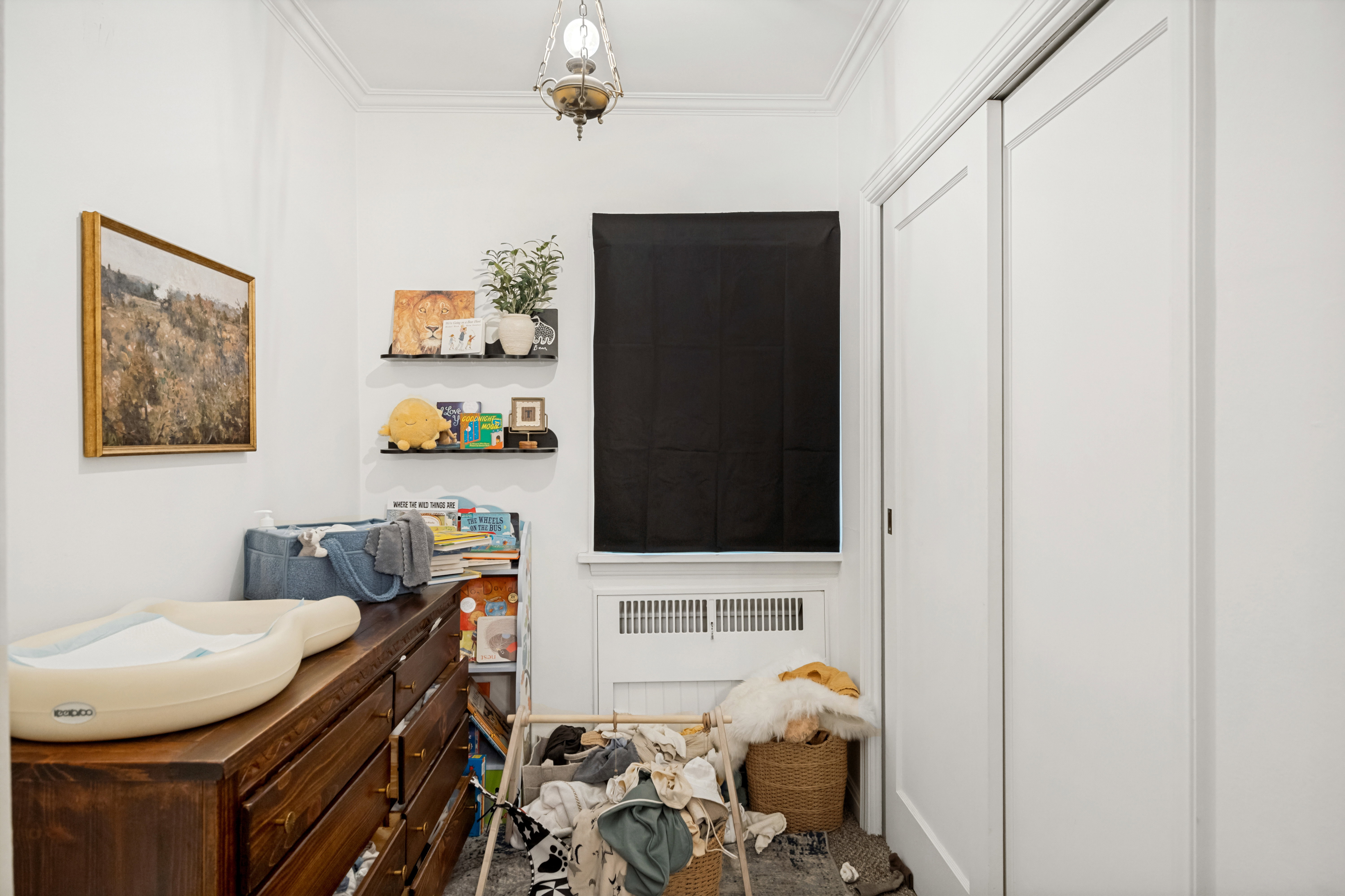 Unit 2 White painted walls with crown molding and a ceiling-mounted fixture
