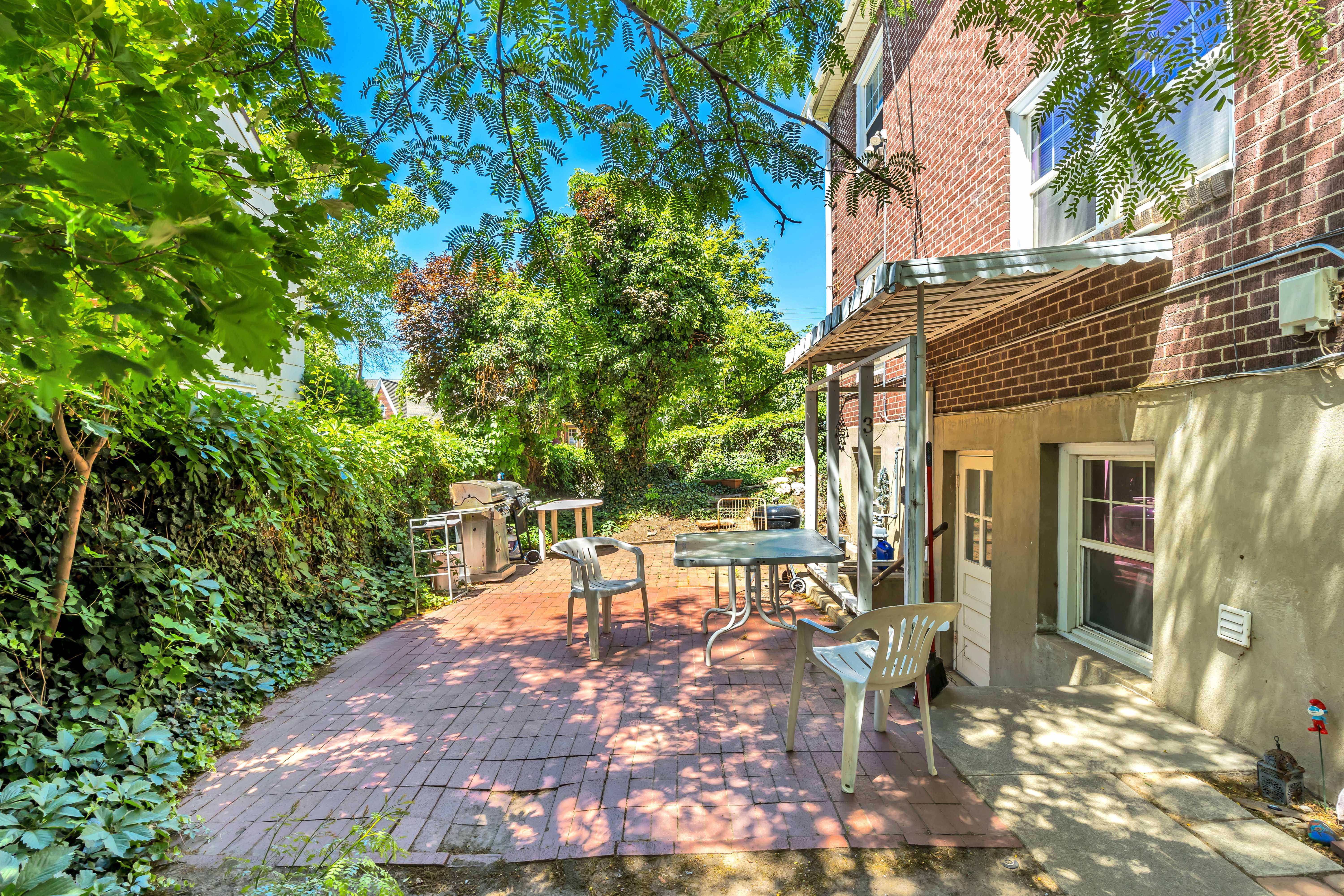 Unit 3 Brick patio area featuring a metal awning and an exterior door