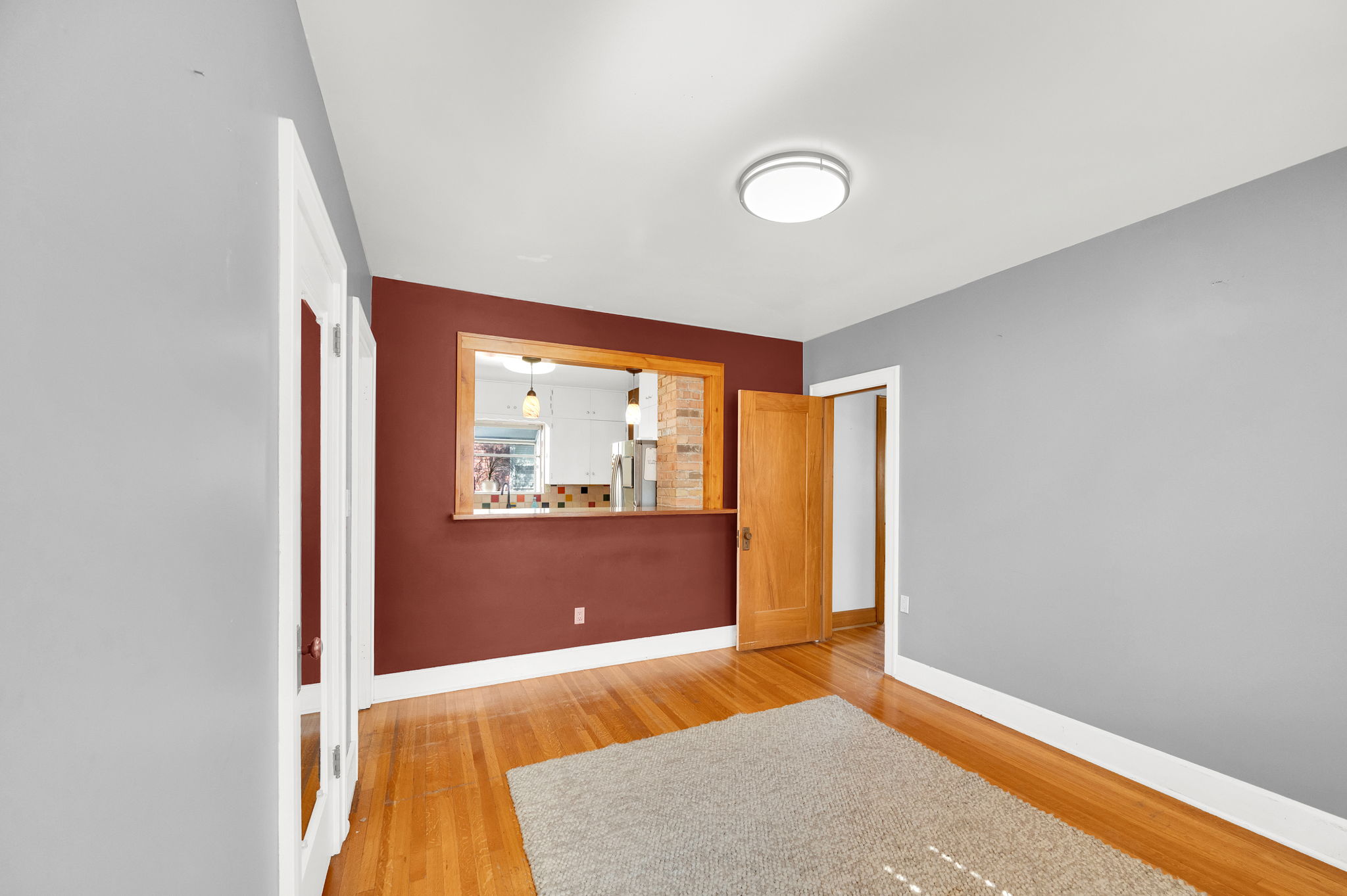 Hardwood flooring throughout, with crisp white baseboards and ceiling trim