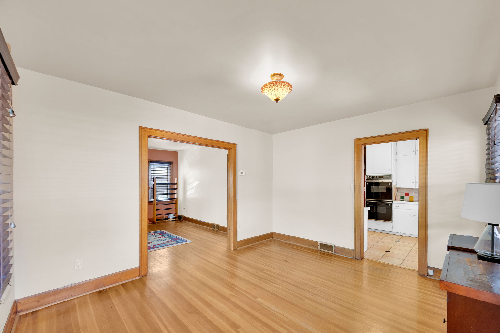 Hardwood flooring spans the room, complemented by white walls and wood-finish trim