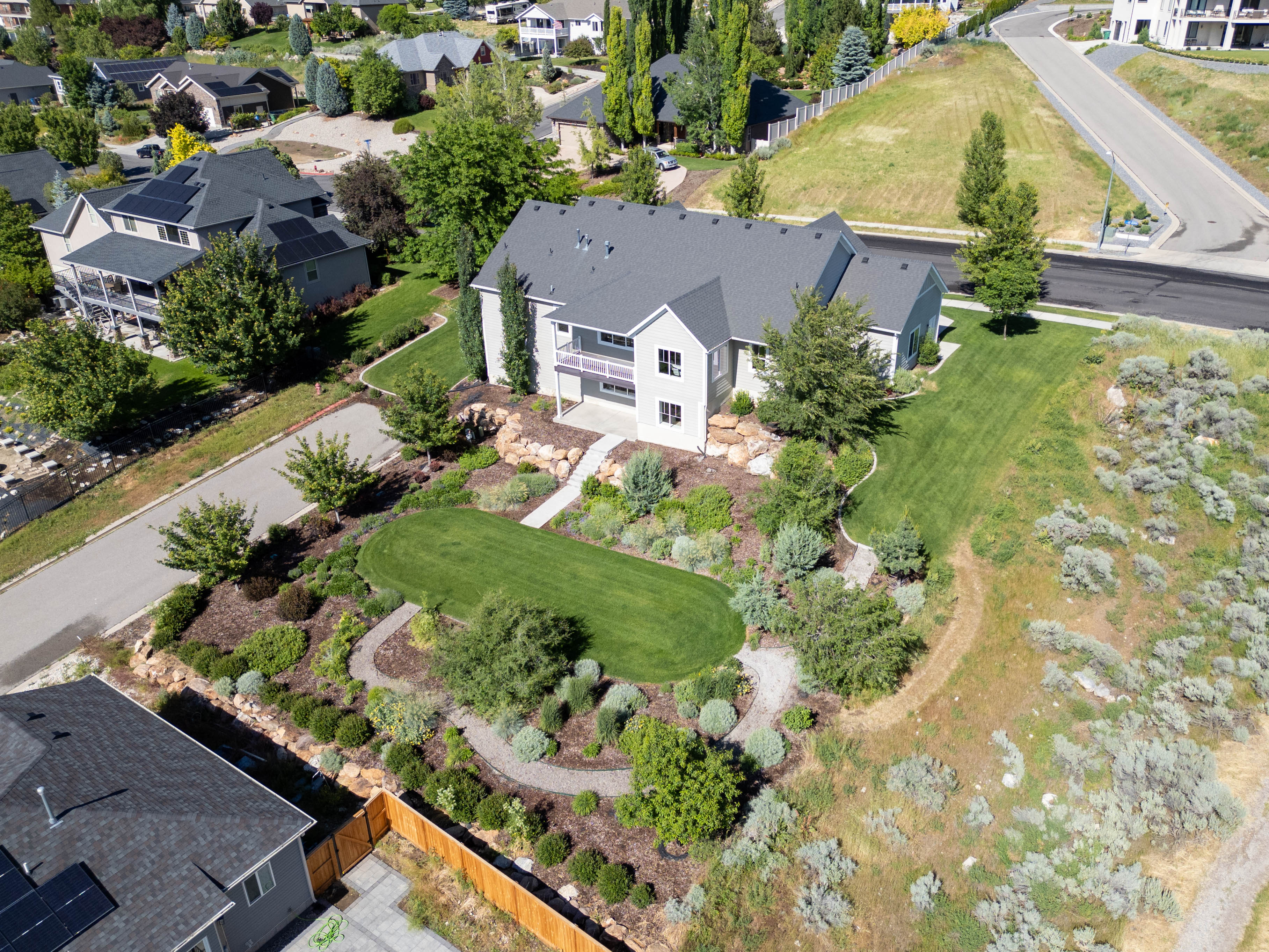 Spacious residence featuring a multi-level design and a dark shingled roof